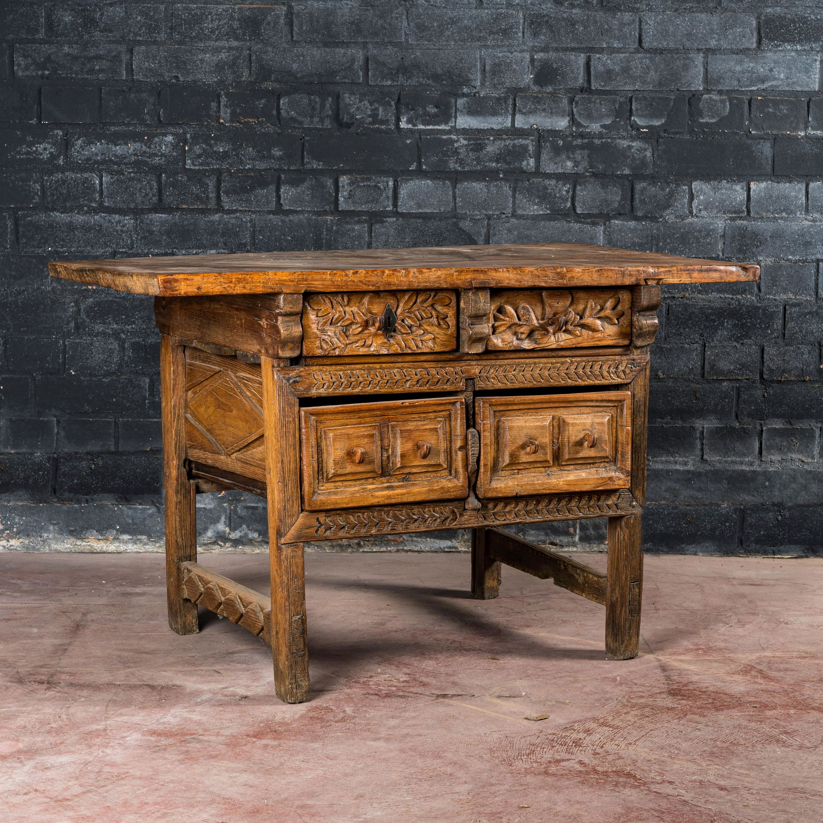 A Spanish carved wooden table with four drawers, 17th C. and/or later (1 of 3)