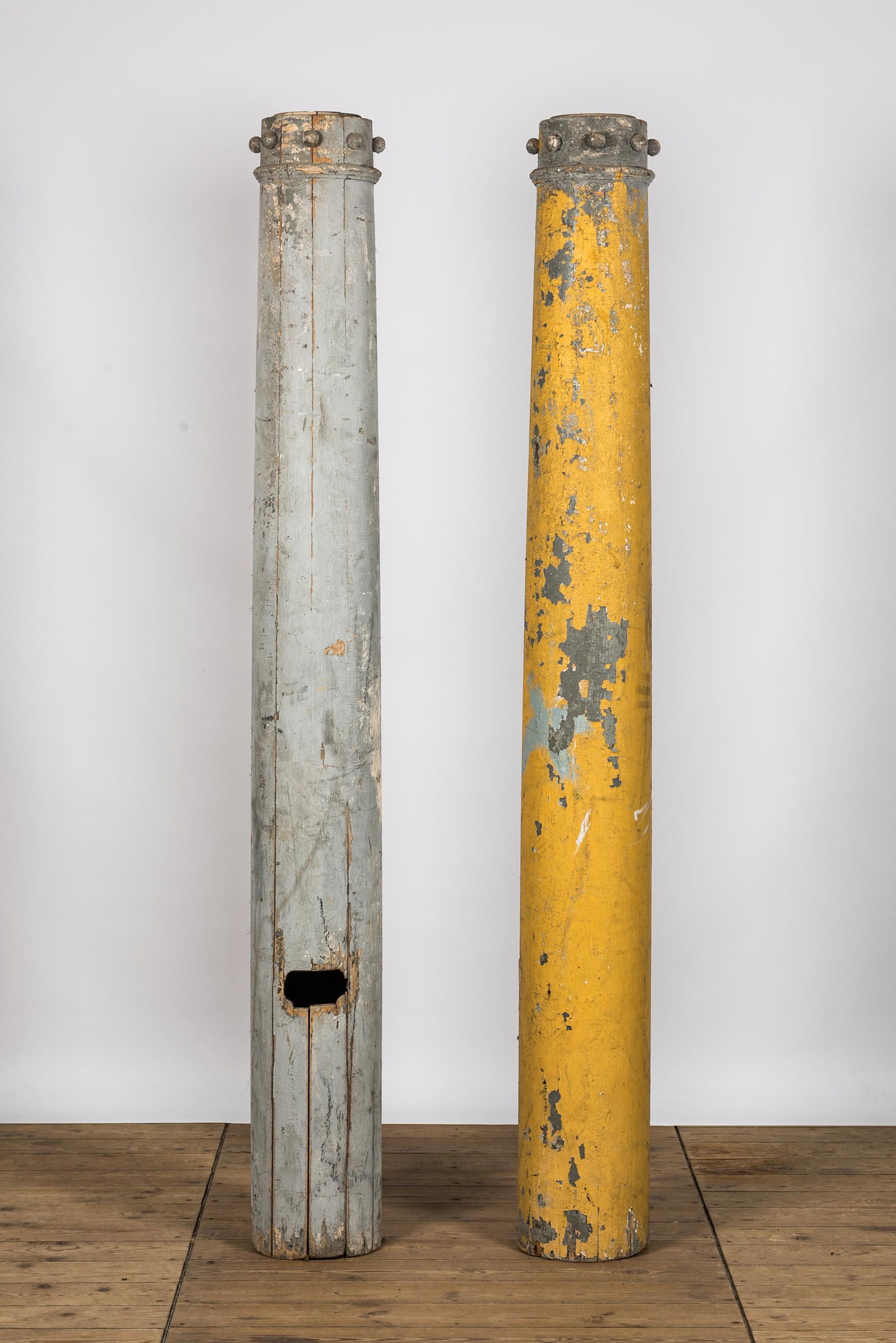 Two grey- and yellow-painted industrial wooden columns, 19/20th C. (1 of 2)