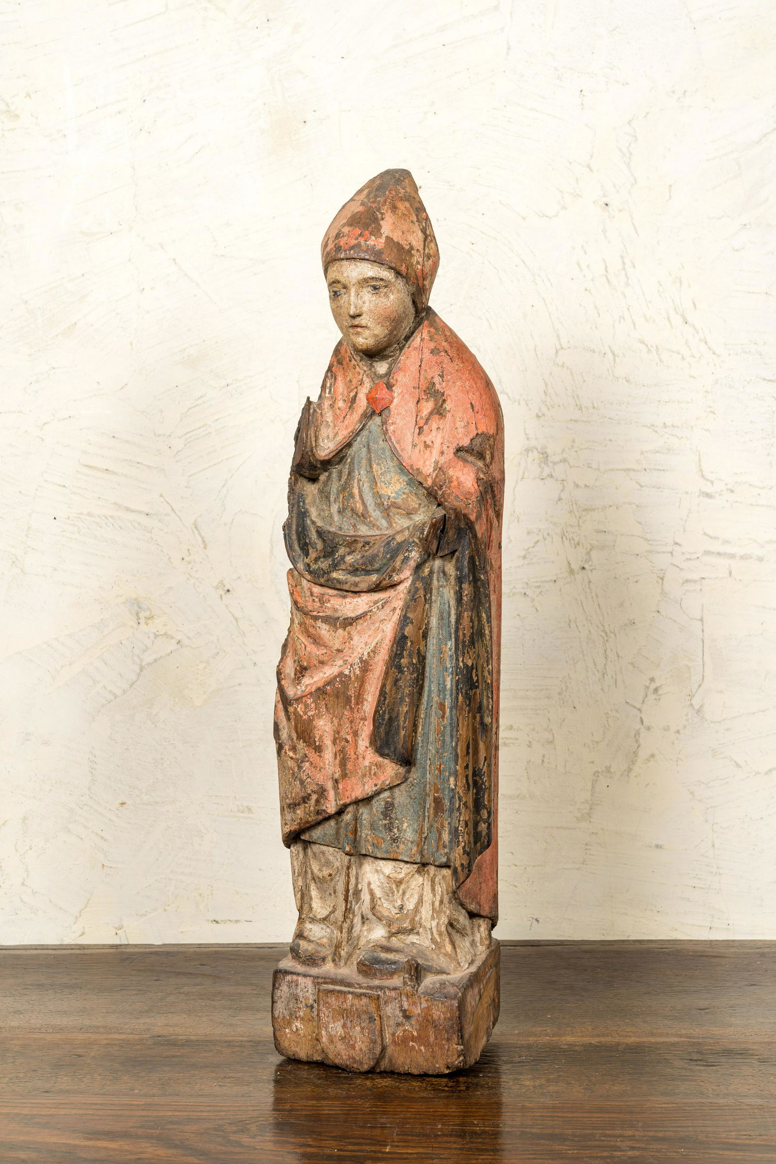 A Flemish carved and polychromed oak figure of a bishop on an armorial base, ca. 1500 (1 of 3)