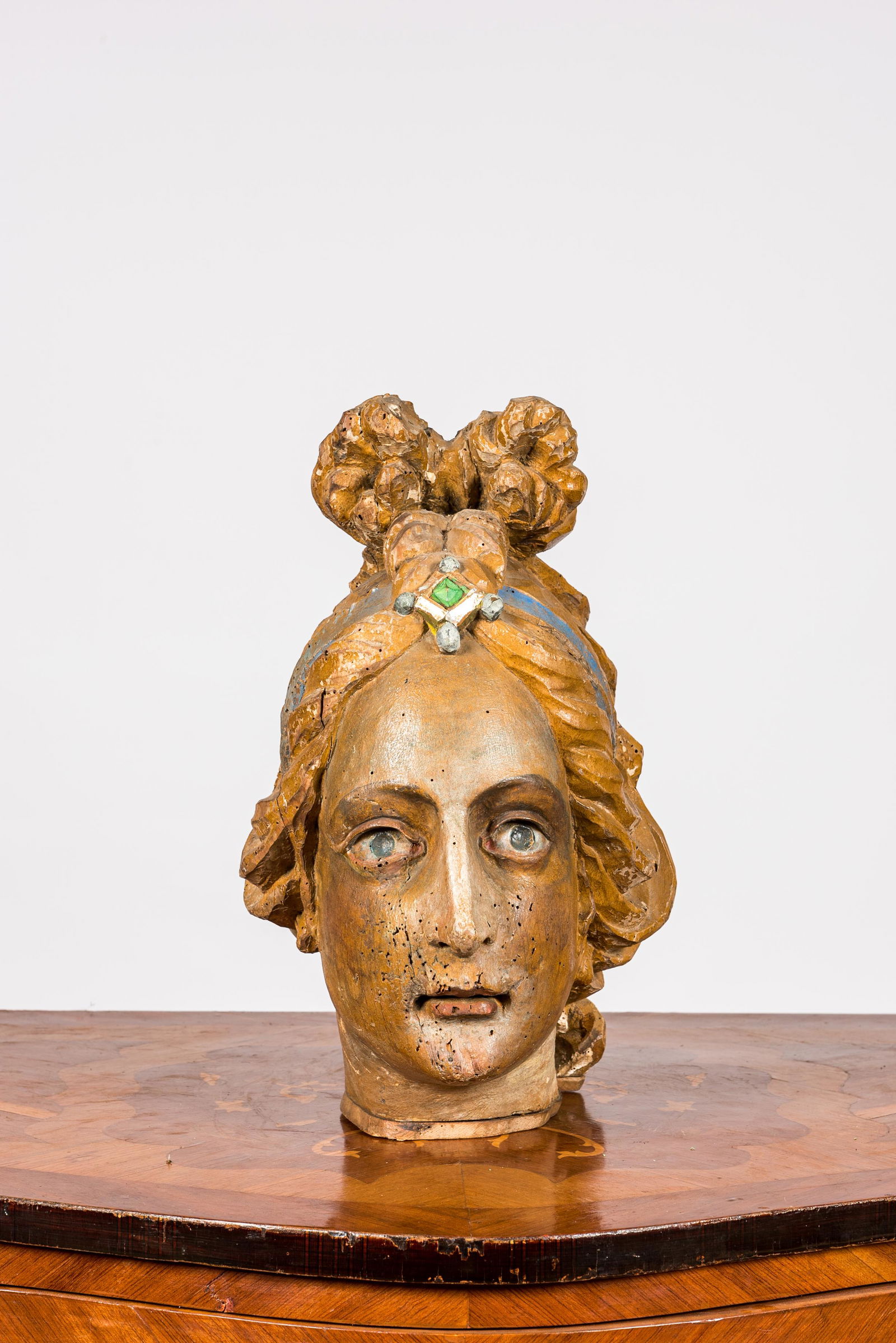 A polychrome wooden head of a female saint, 18th C. (1 of 3)