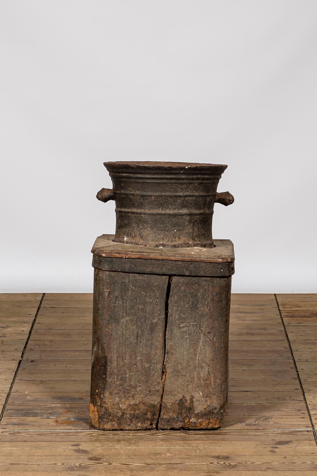 A large iron mortar on wooden stand, 17th C. (1 of 2)