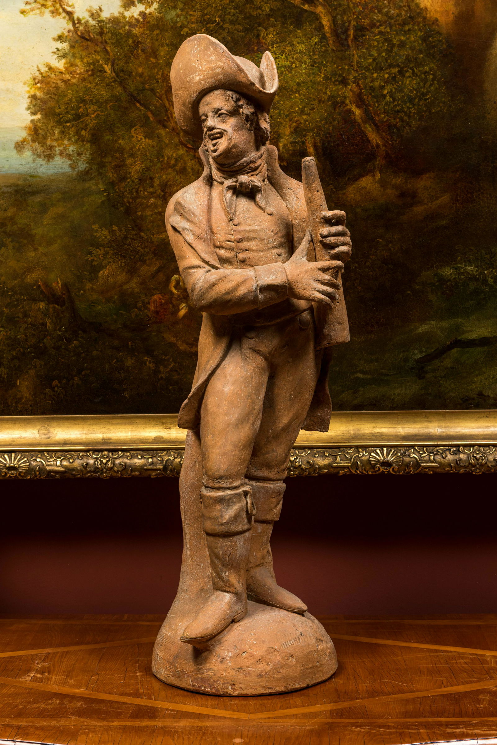 A terracotta figure of a flute player, 19th C. (1 of 2)