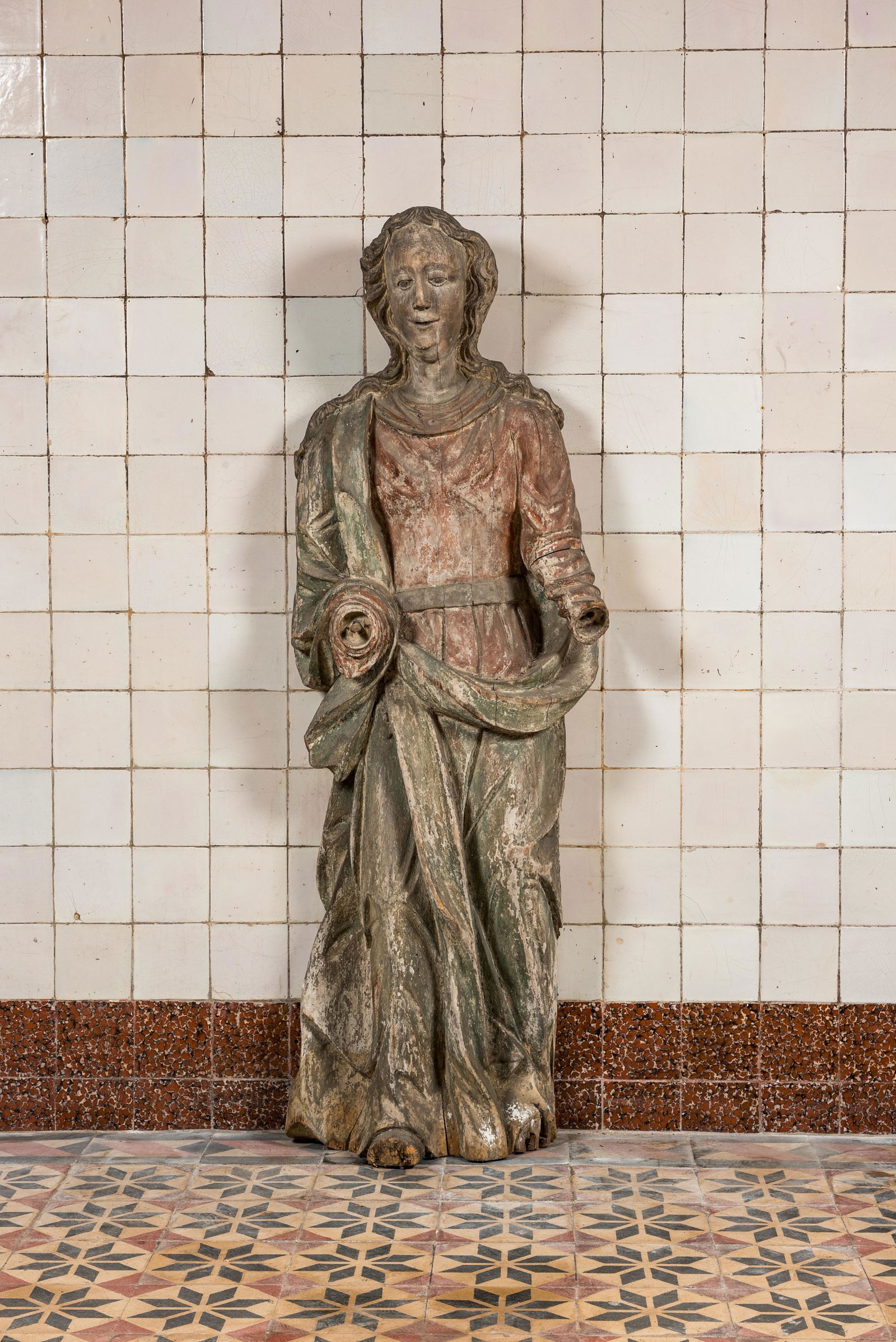 A large polychrome wooden sculpture of a female saint, early 17th C. (1 of 2)