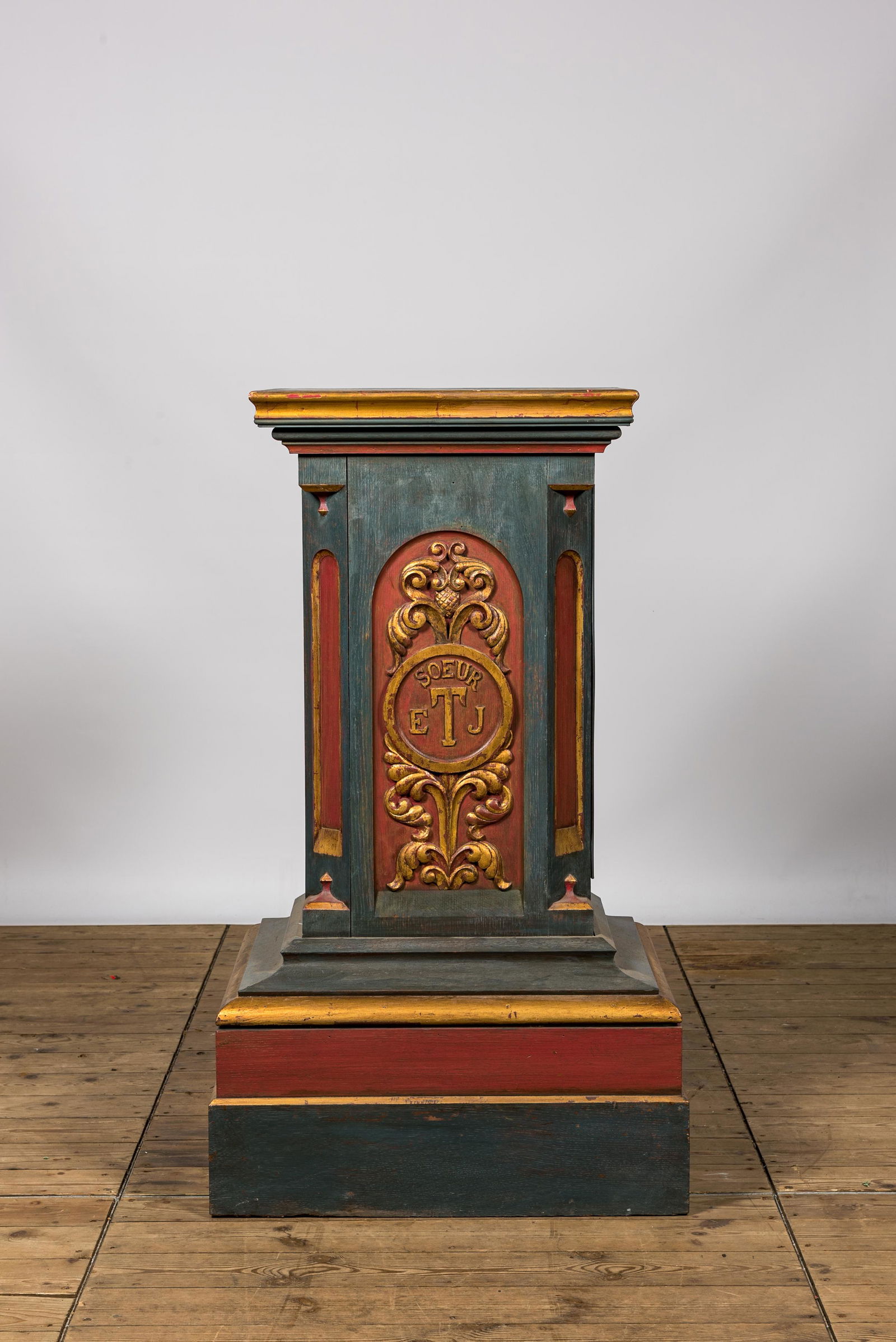A polychromed and gilt monogrammed wooden column with inner compartment, 19th C. (1 of 3)