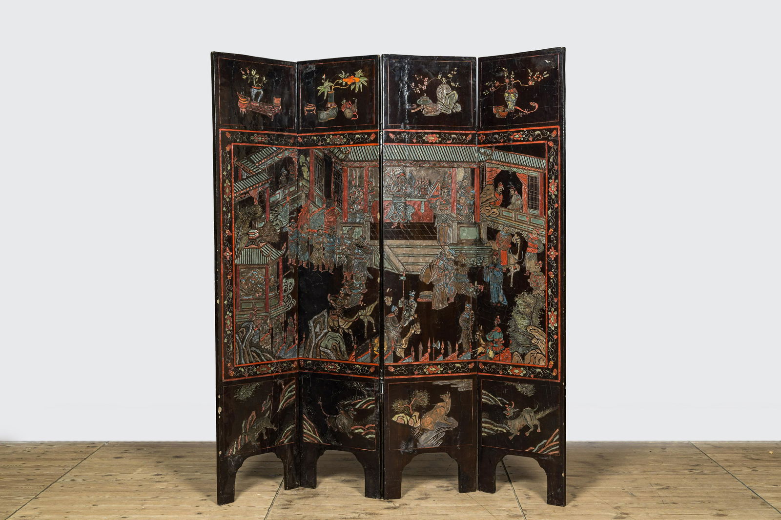 A Chinese lacquered four-part folding screen with a narrative 'palace' scene, 19/20th C. (1 of 6)