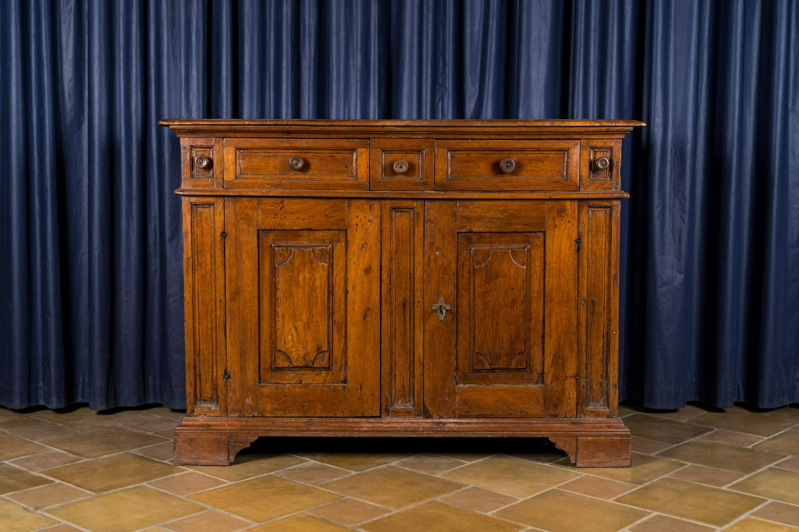 An Italian walnut sideboard with two doors and three drawers, 18th C. (1 of 4)