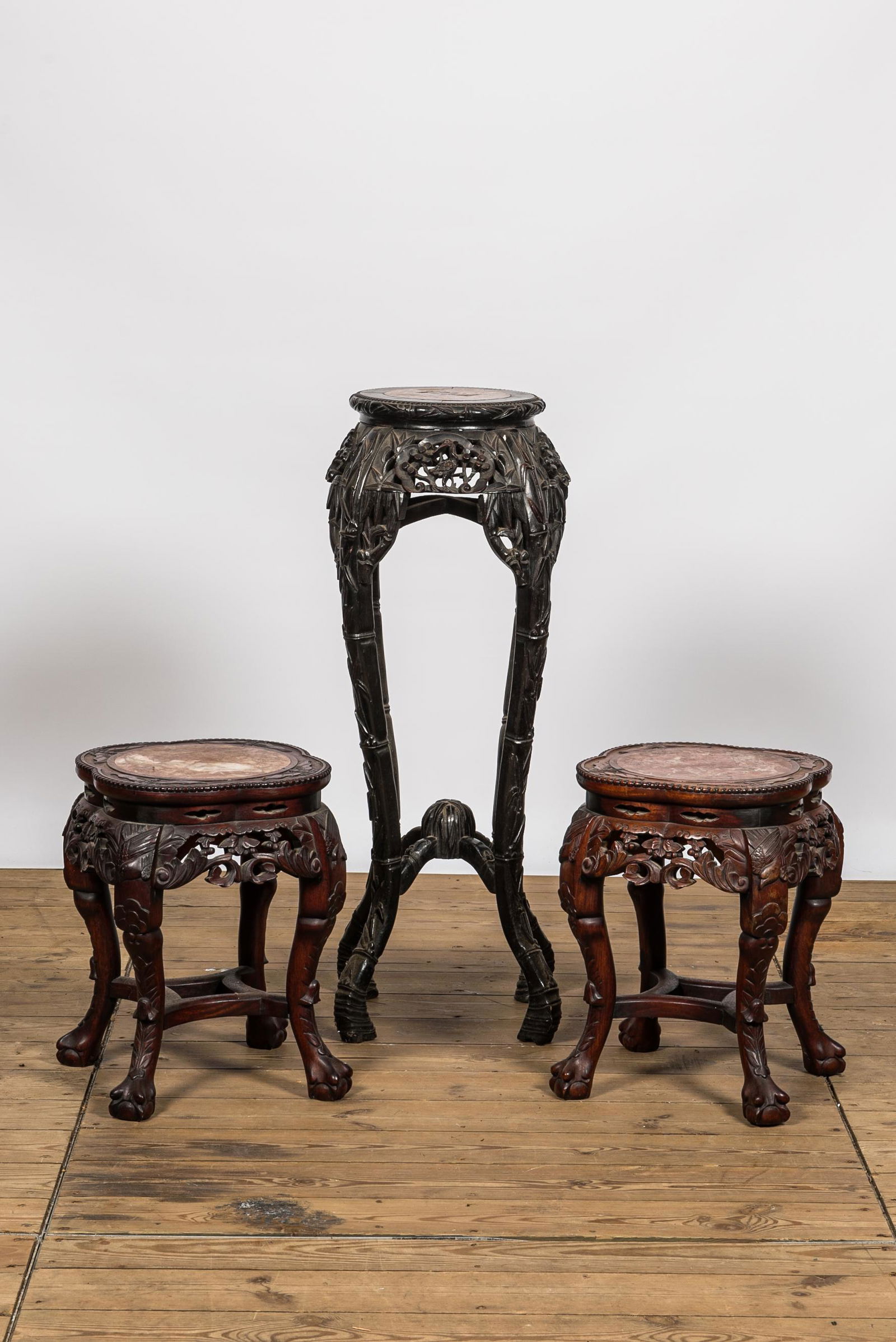 Three Chinese carved wooden stands with marble top, 19/20th C. (1 of 2)