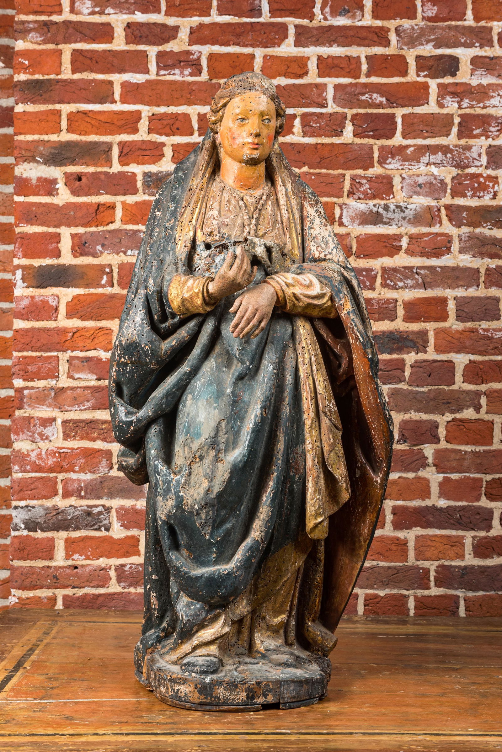 A large polychrome wooden sculpture of a female saint, ca. 1600 (1 of 2)