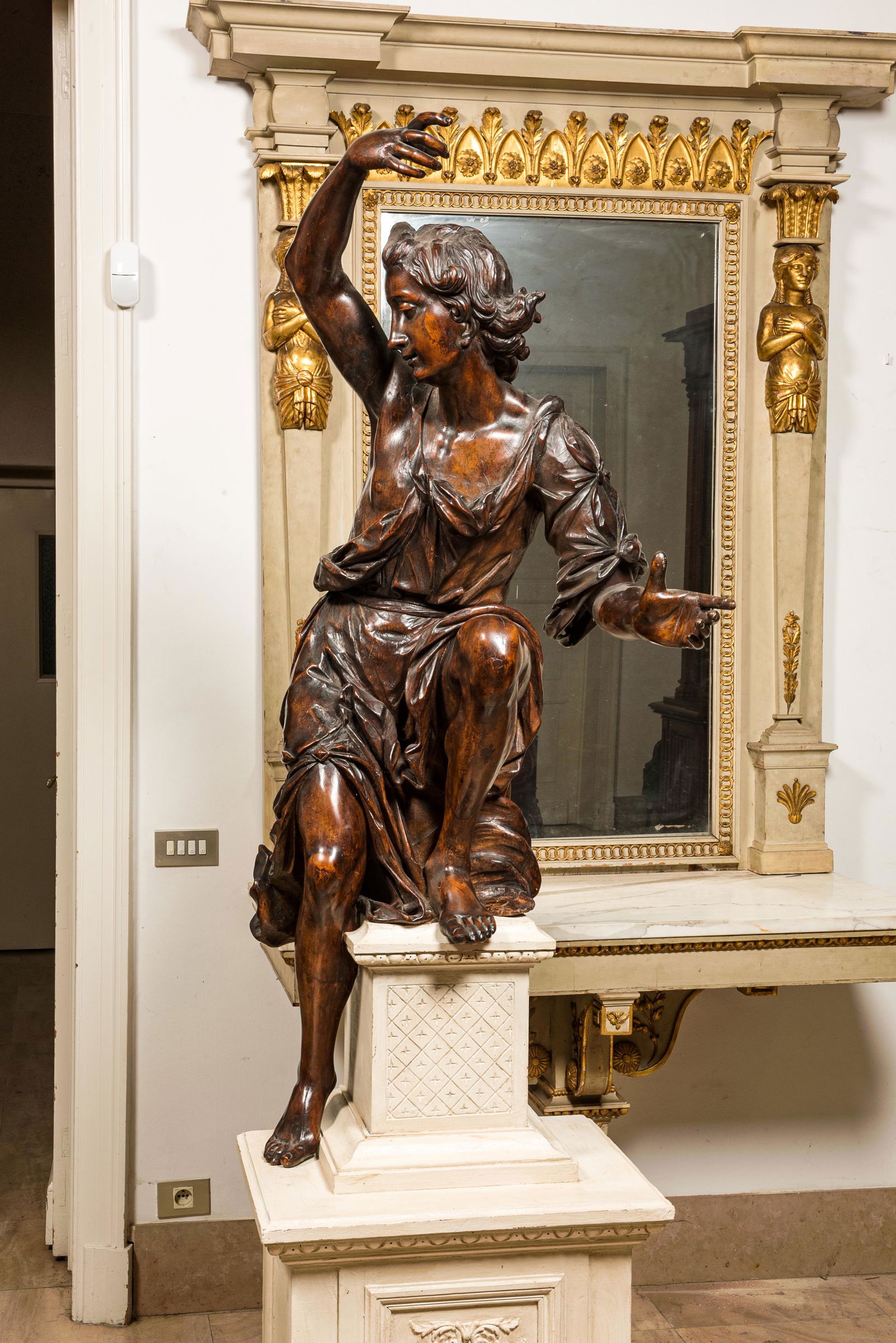 A large walnut figure of an angel, Flanders, 17th C., on a later stand (1 of 6)