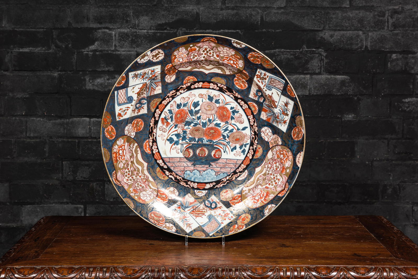 A large Japanese Imari charger with a flower basket, Edo, 18th C. (1 of 2)