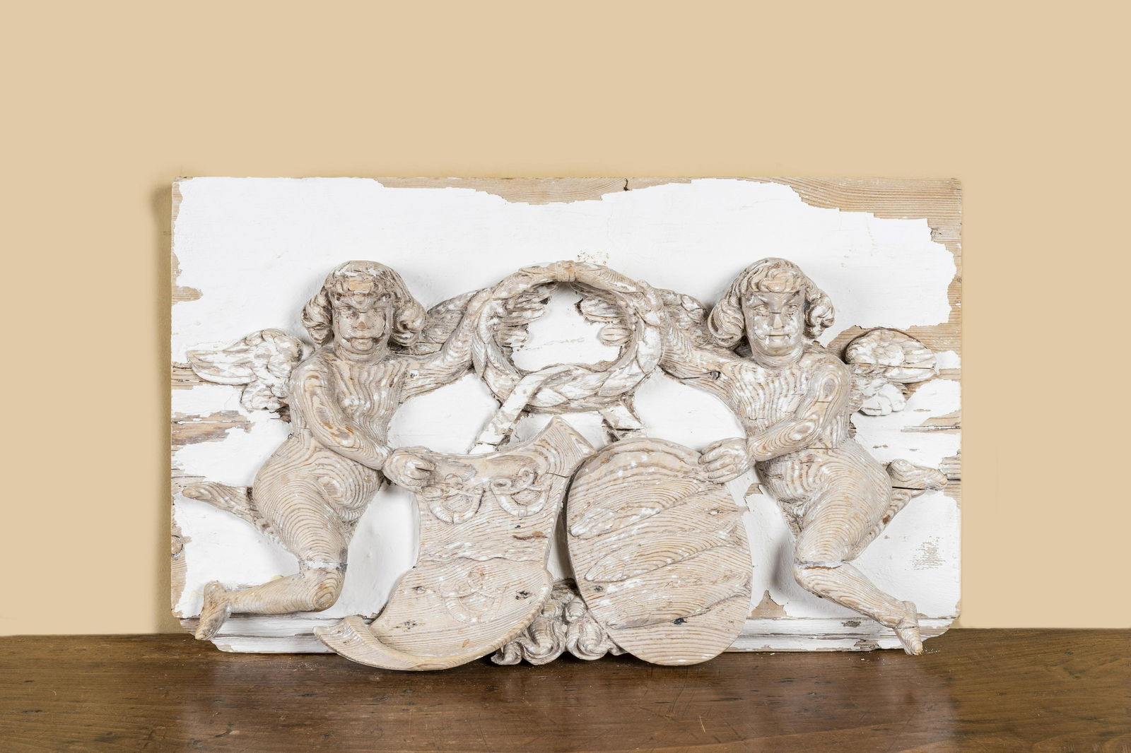 A most probably German patinated wooden relief depicting an alliance weapon carried by putti, 18th (1 of 2)