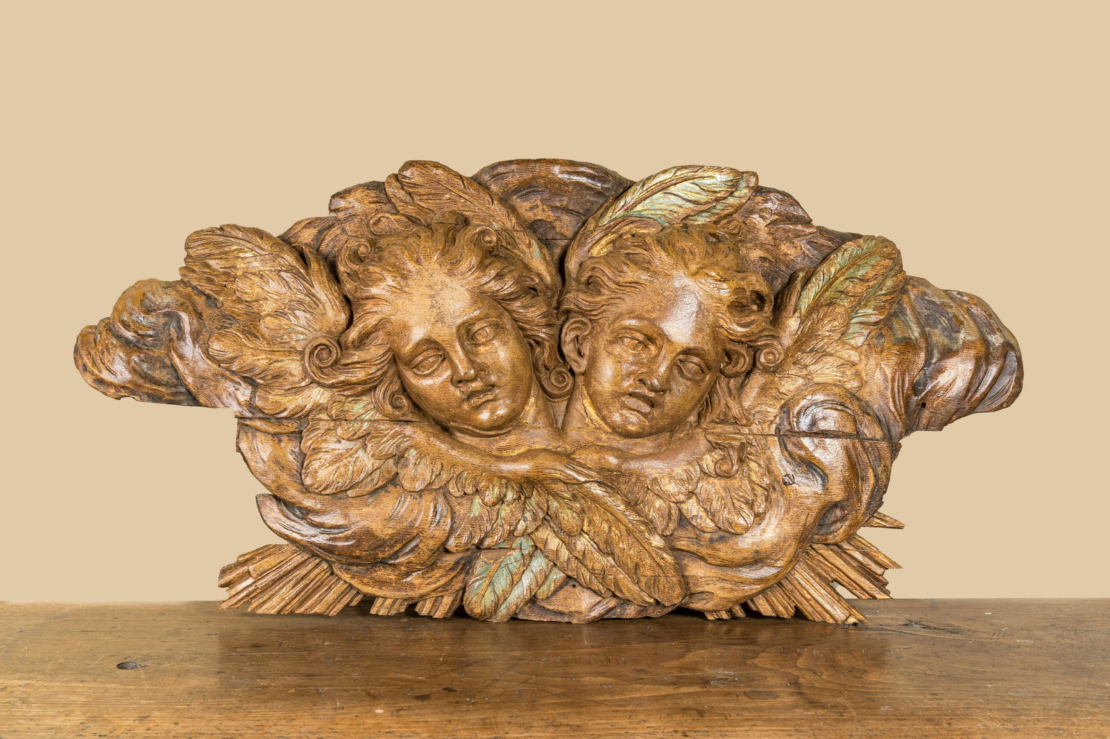 A wooden relief depicting two angels with traces of polychrome and gilt, 18th C. (1 of 3)