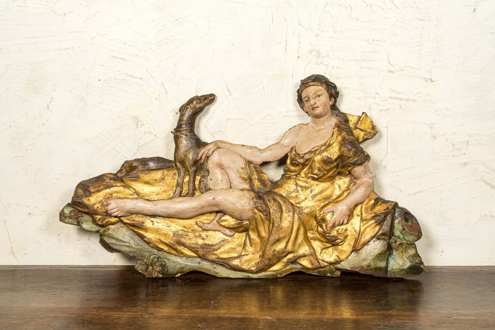 A polychromed and gilt wood carving depicting the goddess Diana and her dog, 17th C.: Full title: A polychromed and gilt wood carving depicting the goddess Diana and her dog, 17th C. Description: H 42 x L 69 cm Expert: Cabinet Benoit Bertrand About this sale: Paul De Grande is one of t