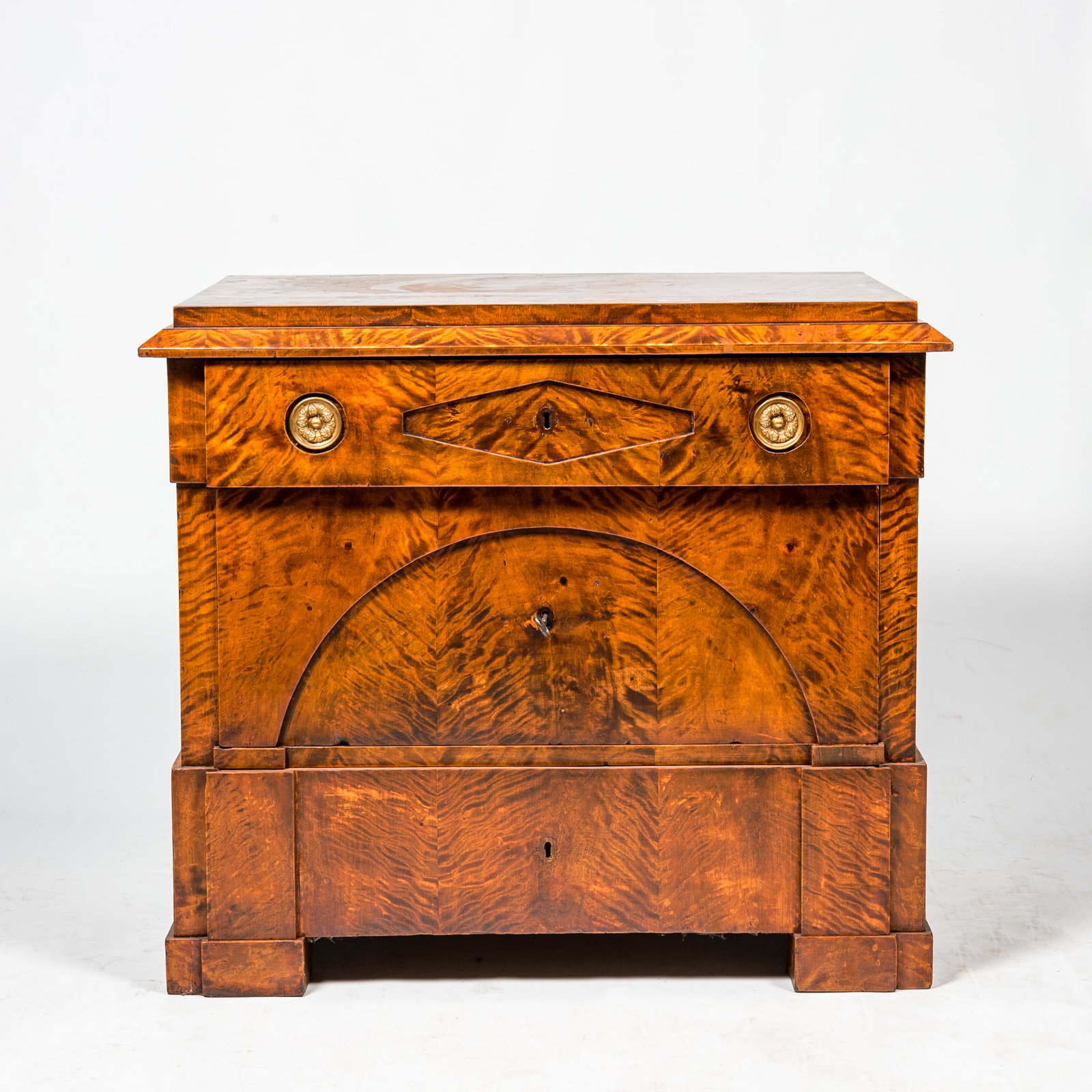 A neoclassical mahogany three-drawer chest, 19th C. (1 of 3)