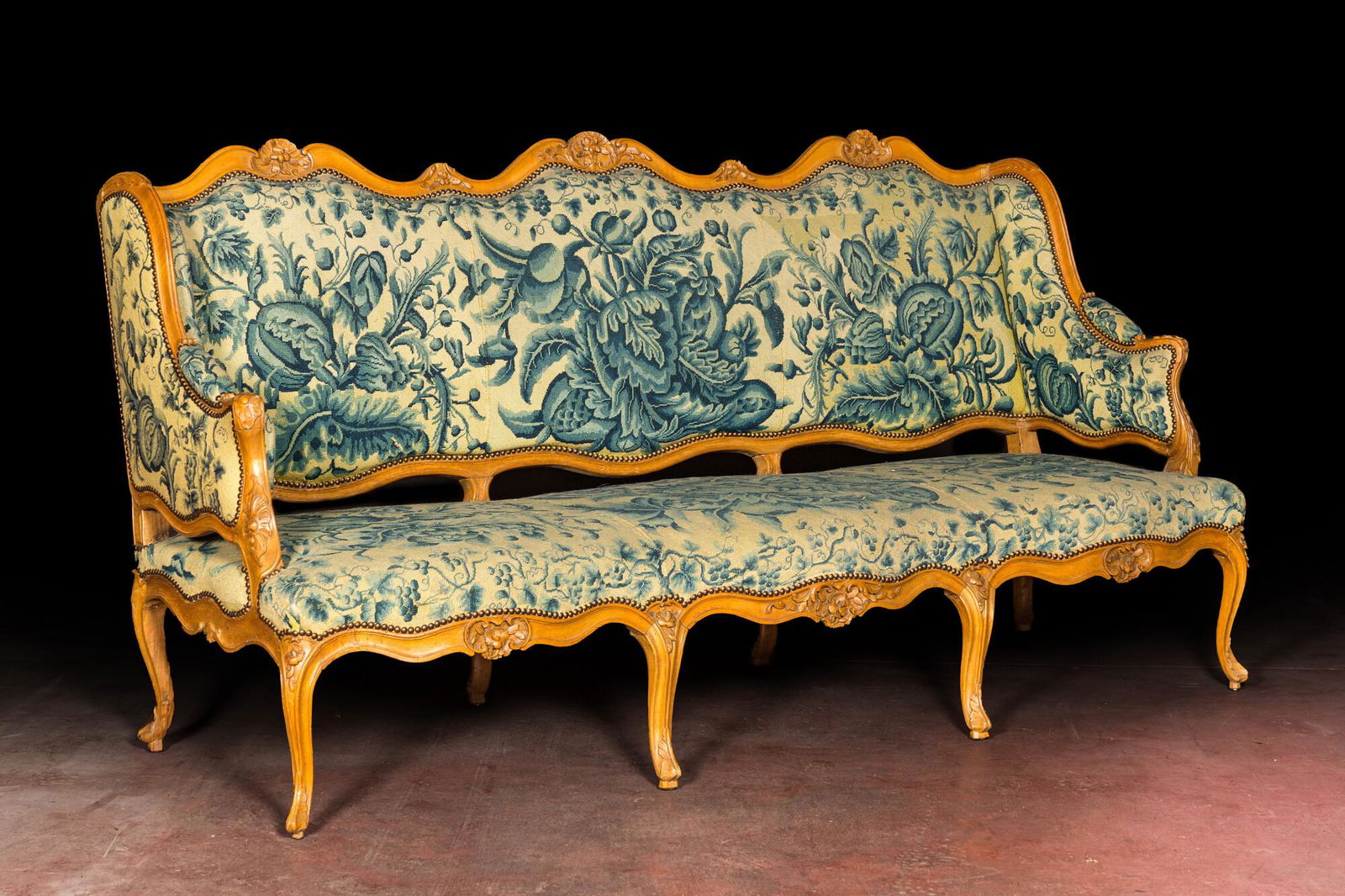 A large French Louis XV beechwooden sofa with embroidered upholstery, 18th C. (1 of 4)