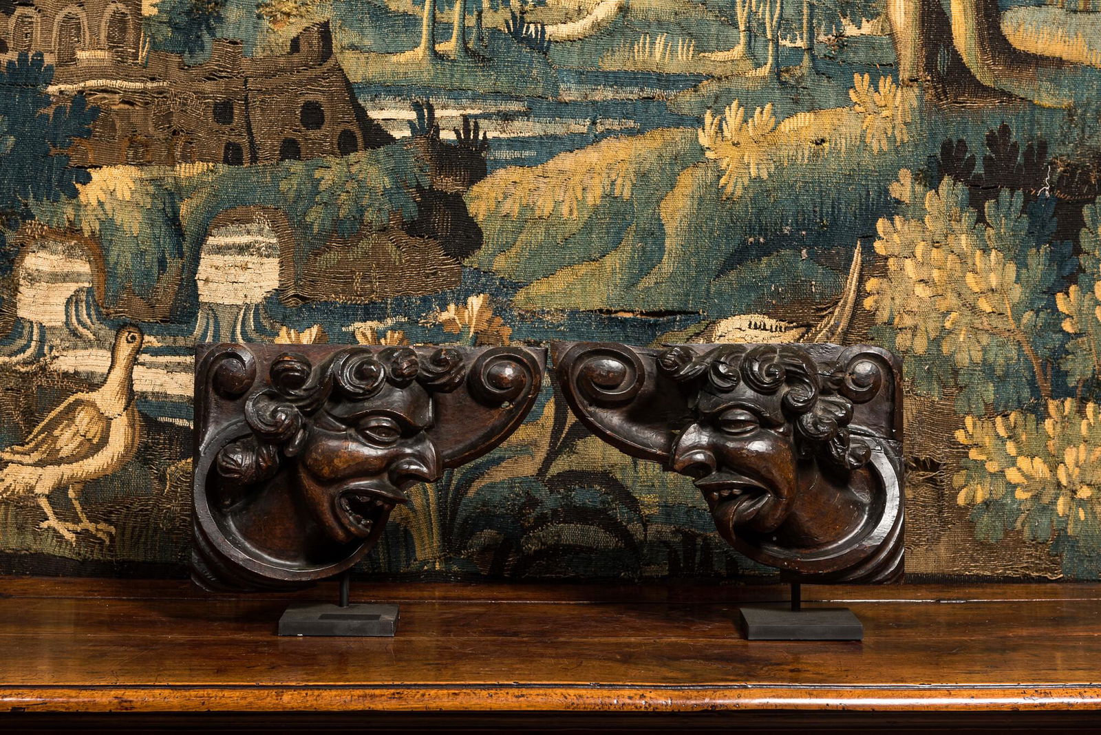 A pair of carved oak reliefs with devils' heads, 17th C. (1 of 2)