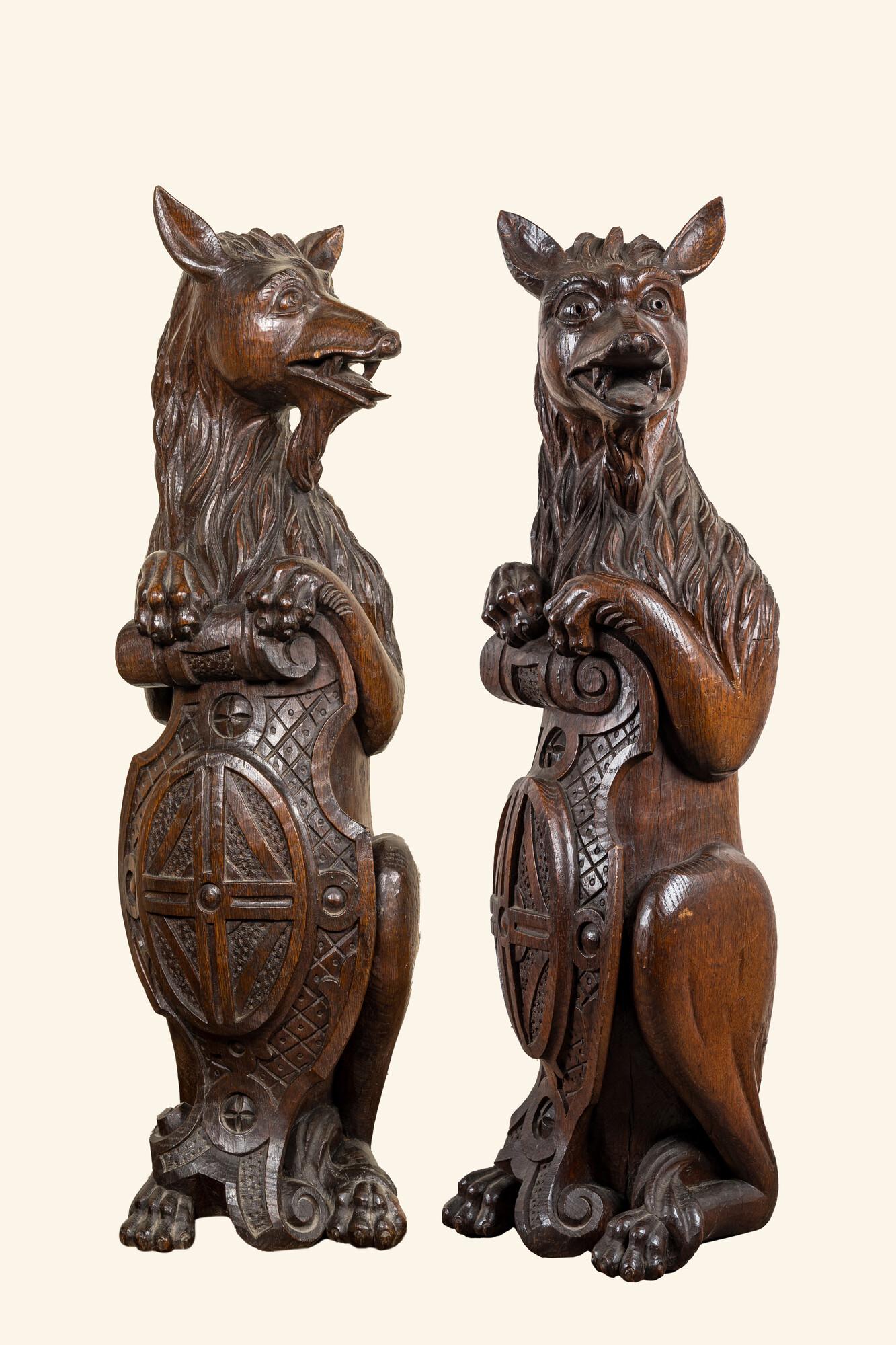 Two oak sculptures of mythical creatures with a shield, 19th C.: Full title: Two oak sculptures of mythical creatures with a shield, 19th C. Description: H 76 cm About this sale: Paul De Grande is one of the major dealers of antique furniture, fine sculptures and d