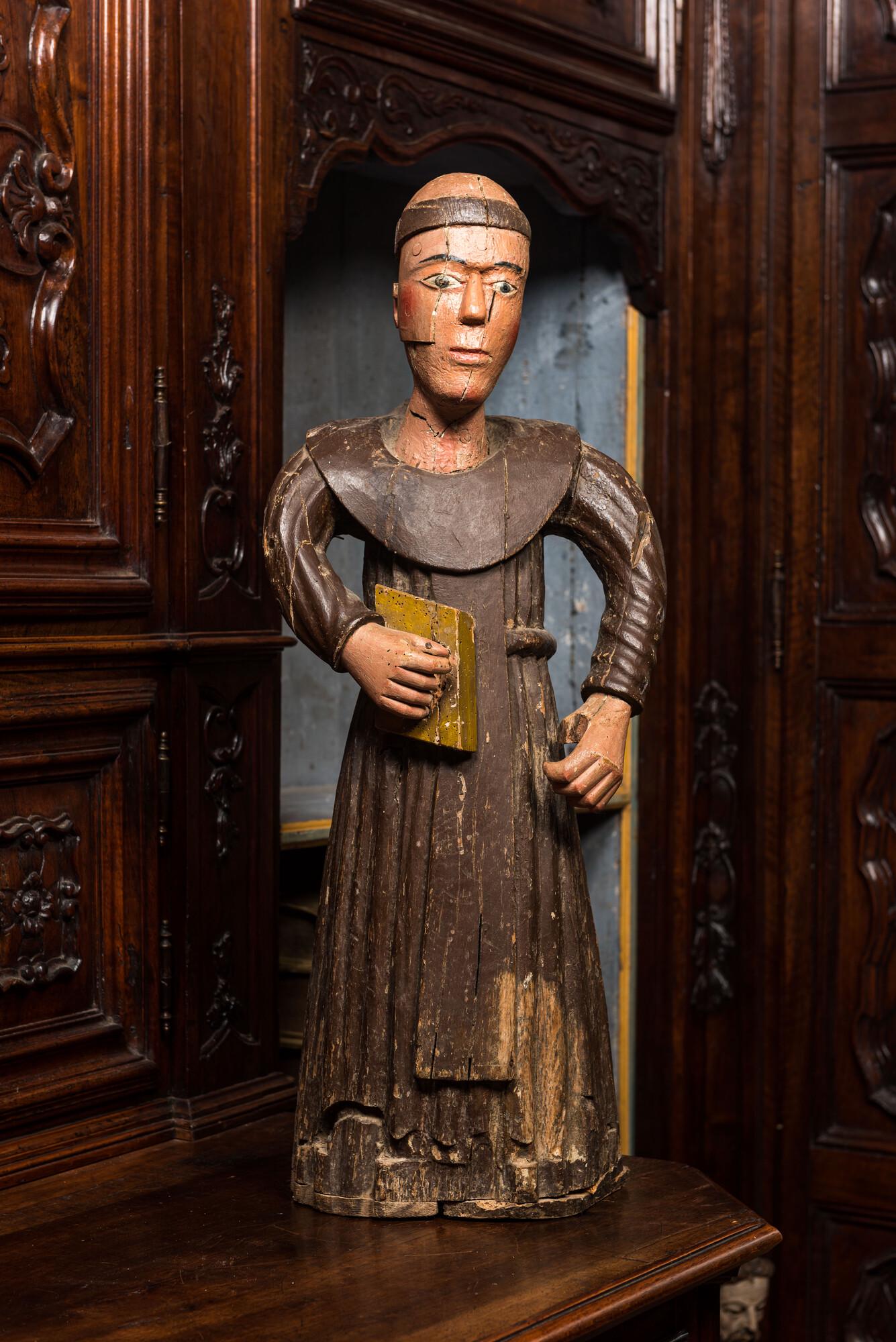 A polychrome wooden sculpture of a monk, 17/18th C. (1 of 2)
