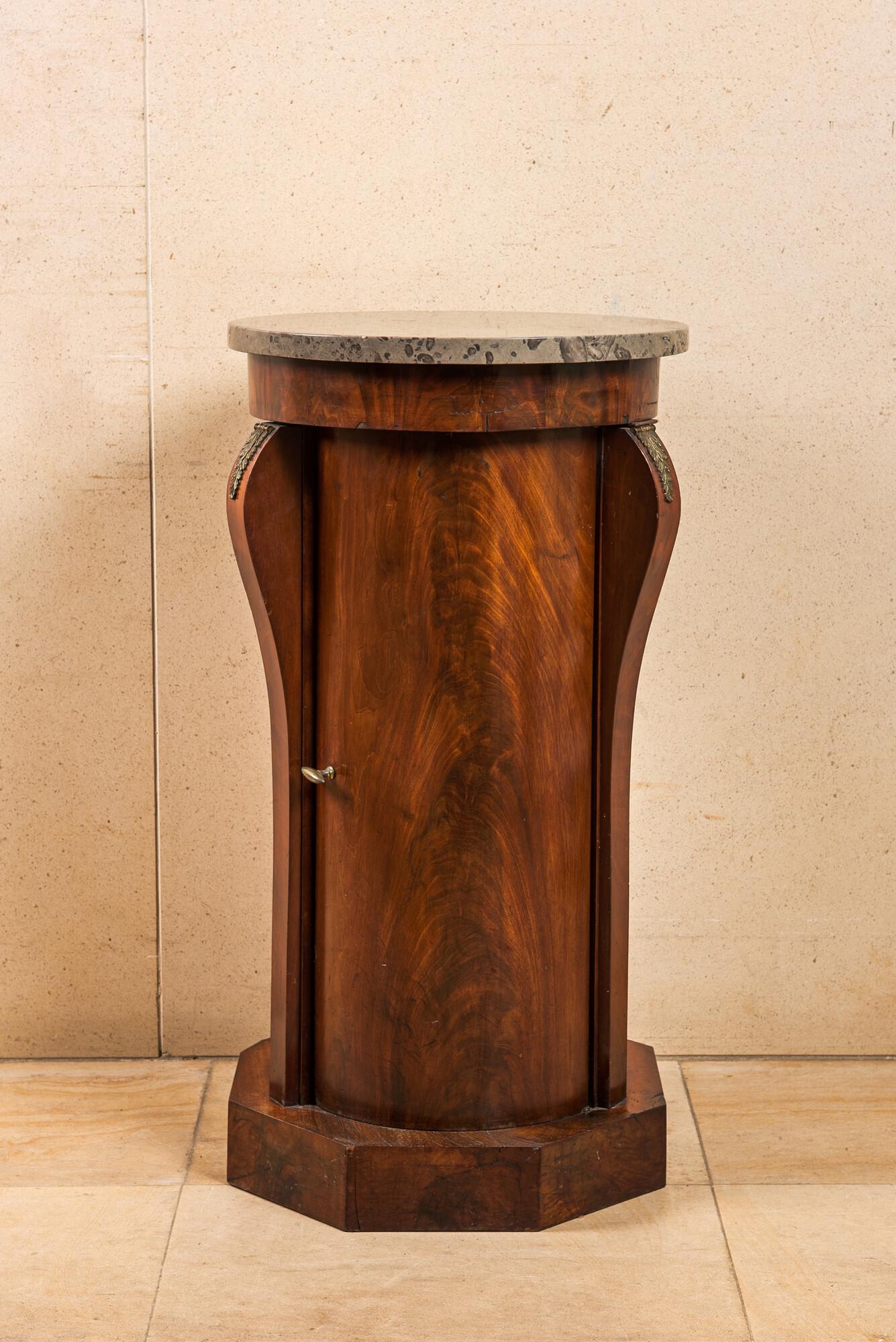 A French round mahogany wooden one-door cabinet stand with marble top, 19th C. (1 of 2)