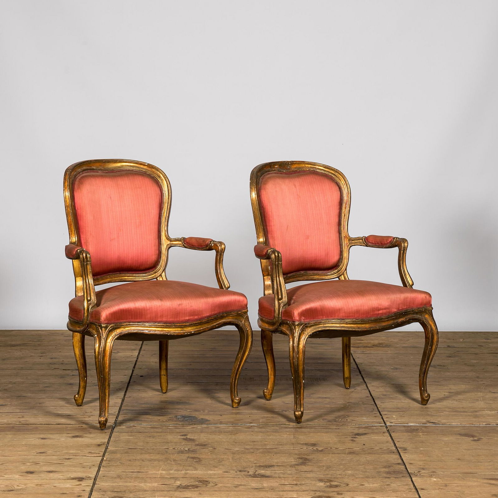 Two French Louis XV-style gilt wooden upholstered armchairs, 19th C. (1 of 2)