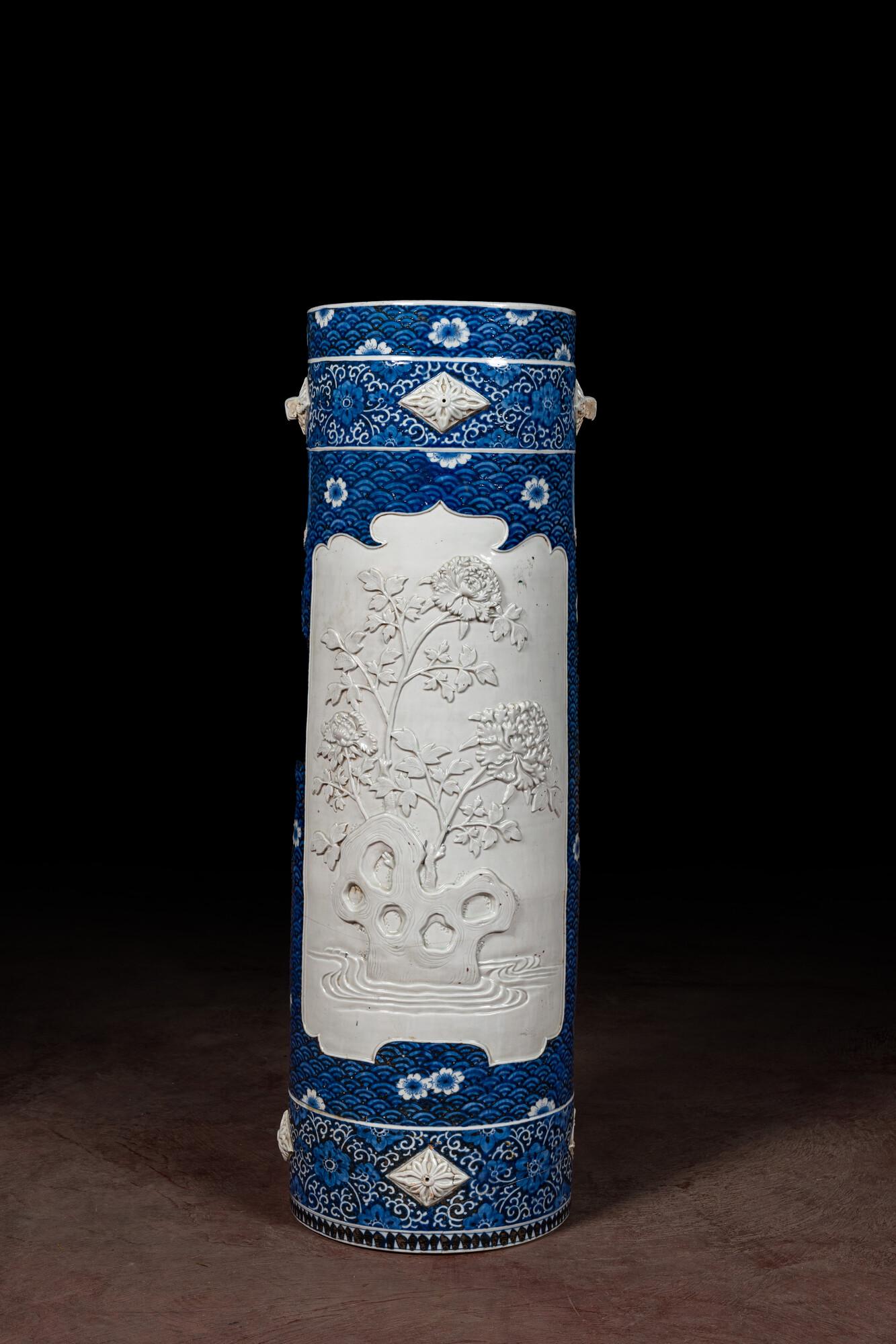 A large blue and white Arita porcelain cylindrical vase or umbrella stand with molded design, Japan, (1 of 2)