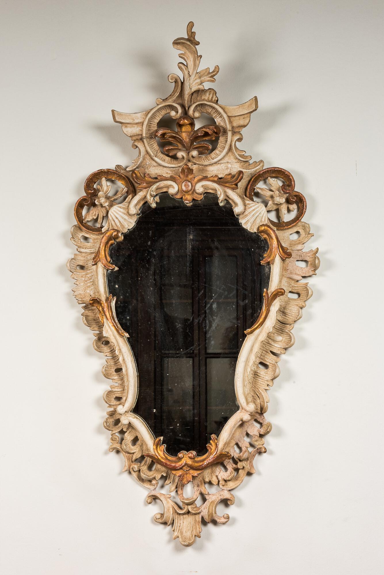 An Italian patinated and gilt wooden mirrors, 18/19th C.: Full title: An Italian patinated and gilt wooden mirrors, 18/19th C. Description: 111 x 56 cm About this sale: Paul De Grande is one of the major dealers of antique furniture, fine sculptures and deco