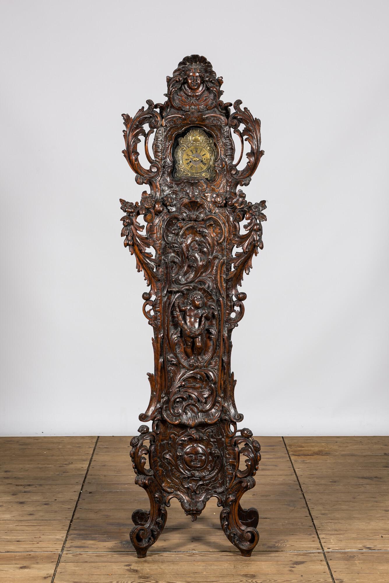 A richly carved walnut tripod clock, 19th C. (1 of 3)