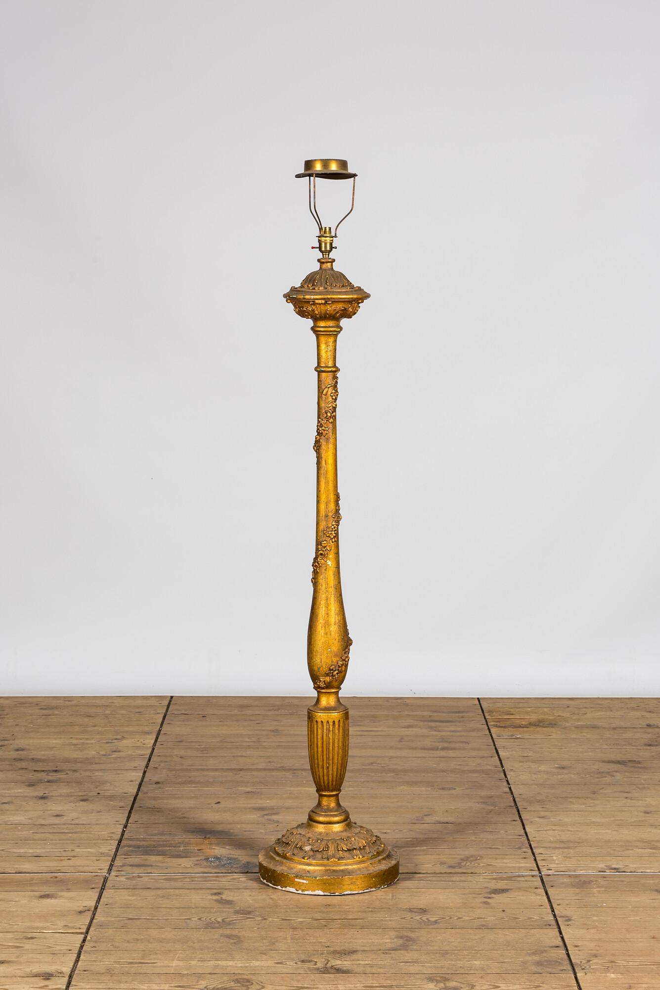 A large gilt carved wooden candlestick mounted as a lamp, 19th C.: Full title: A large gilt carved wooden candlestick mounted as a lamp, 19th C. Description: H 164,5 cm About this sale: Paul De Grande is one of the major dealers of antique furniture, fine sculptures 