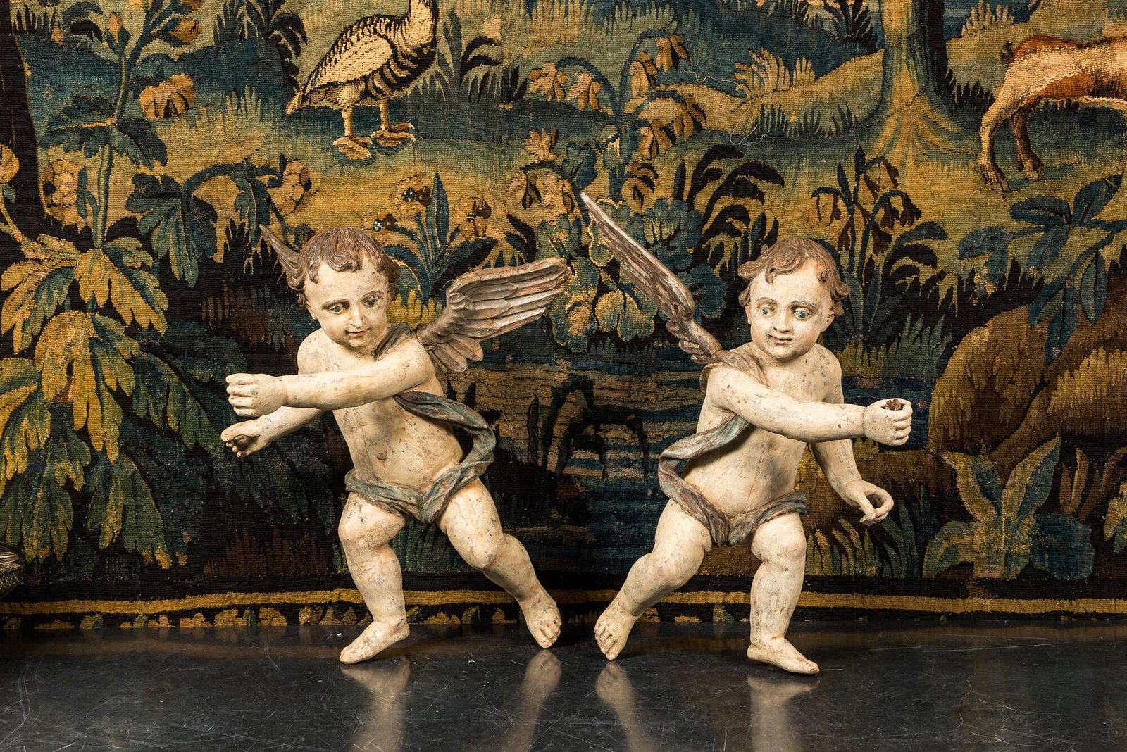 A pair of large polychrome wooden winged cherubs, 19th C.: Full title: A pair of large polychrome wooden winged cherubs, 19th C. Description: H 63,5 cm About this sale: Paul De Grande is one of the major dealers of antique furniture, fine sculptures and decor
