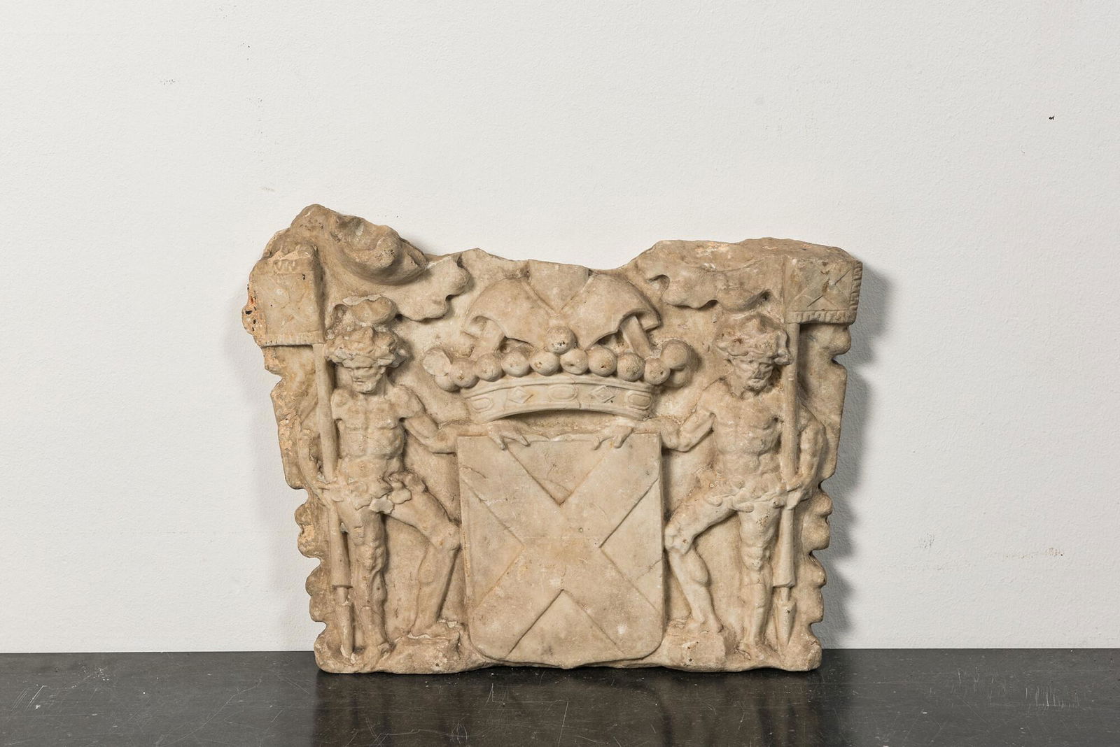A marble relief with a coat of arms flanked by two wild men, 17th C. (1 of 2)