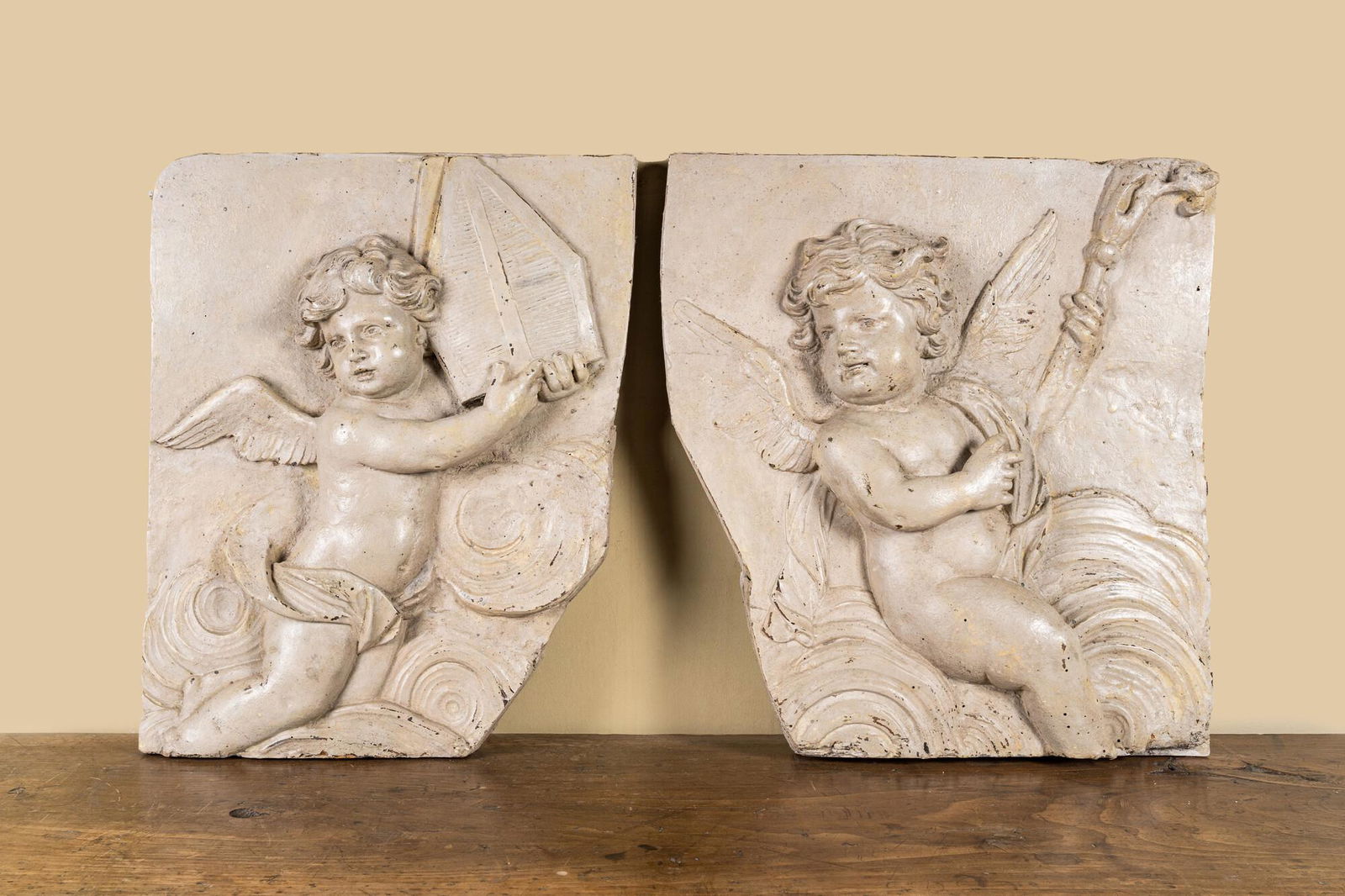 Two French patinated wooden reliefs with putti wearing cardinal attributes, 17/18th C. (1 of 3)