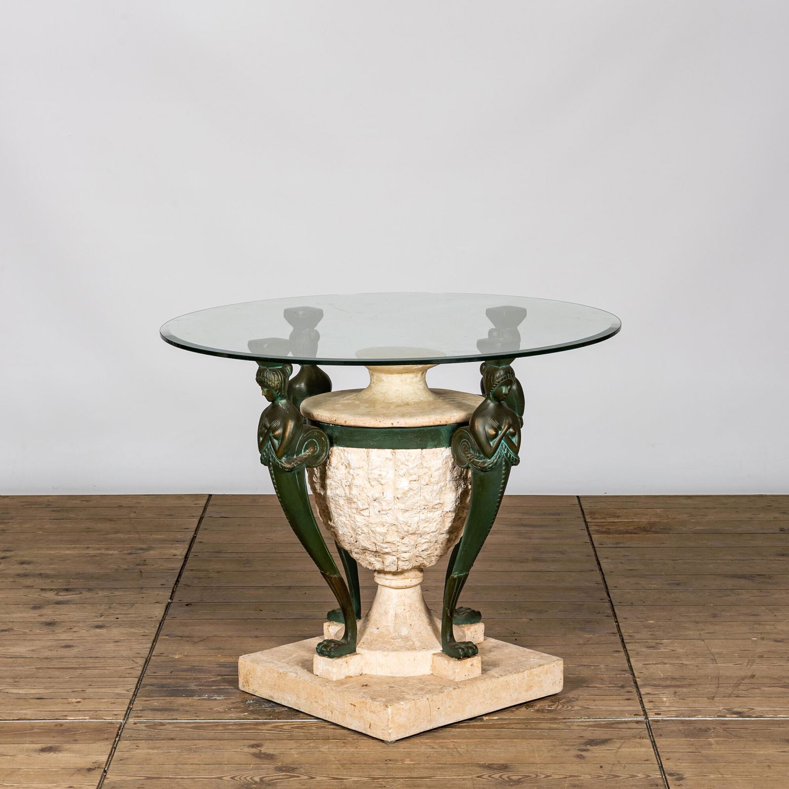 A bronze patinated metal and composite garden table with glass top, 20th C. (1 of 2)