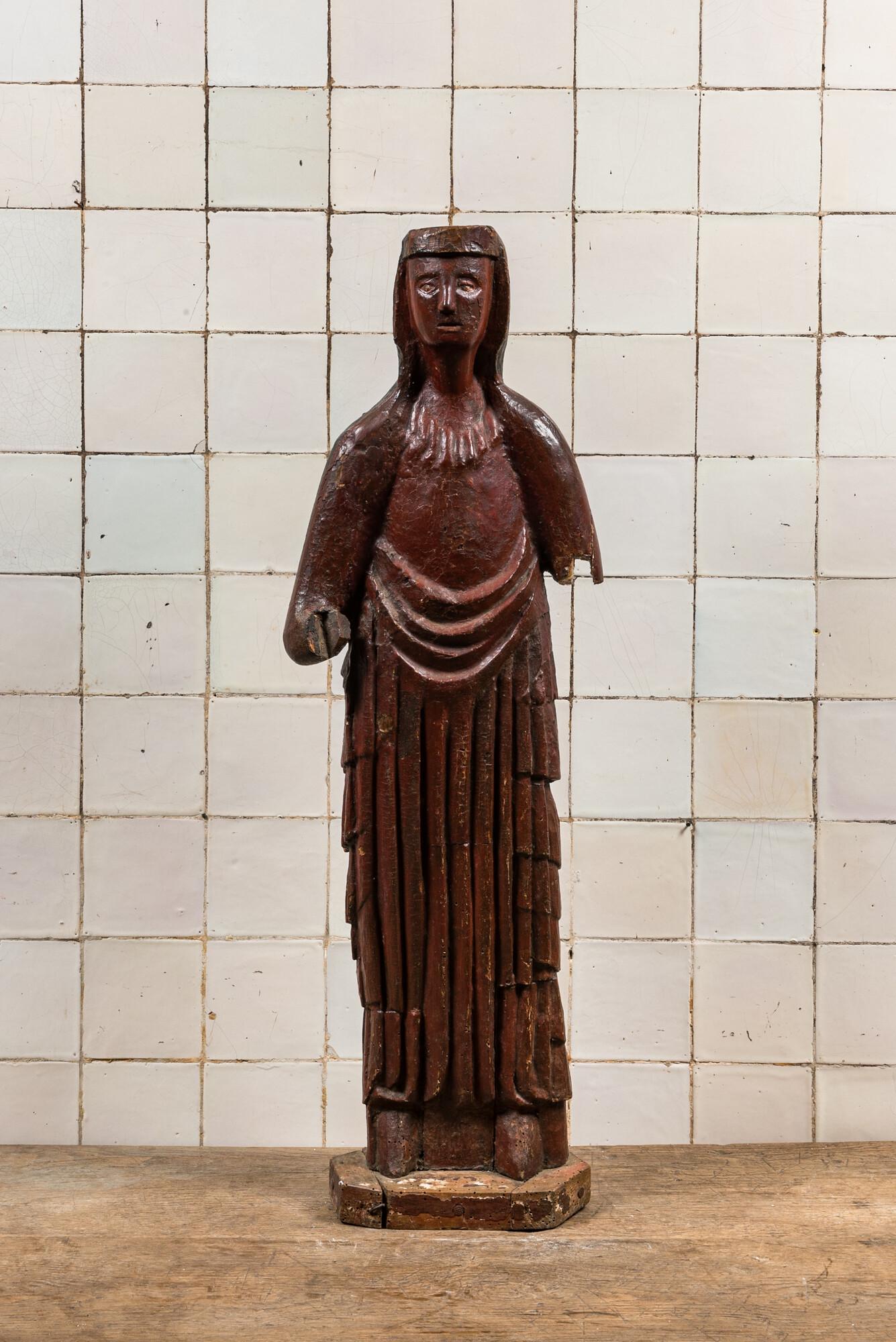 A large polychromed carved wooden folk art figure of a female saint, North of France, probably 16th (1 of 3)
