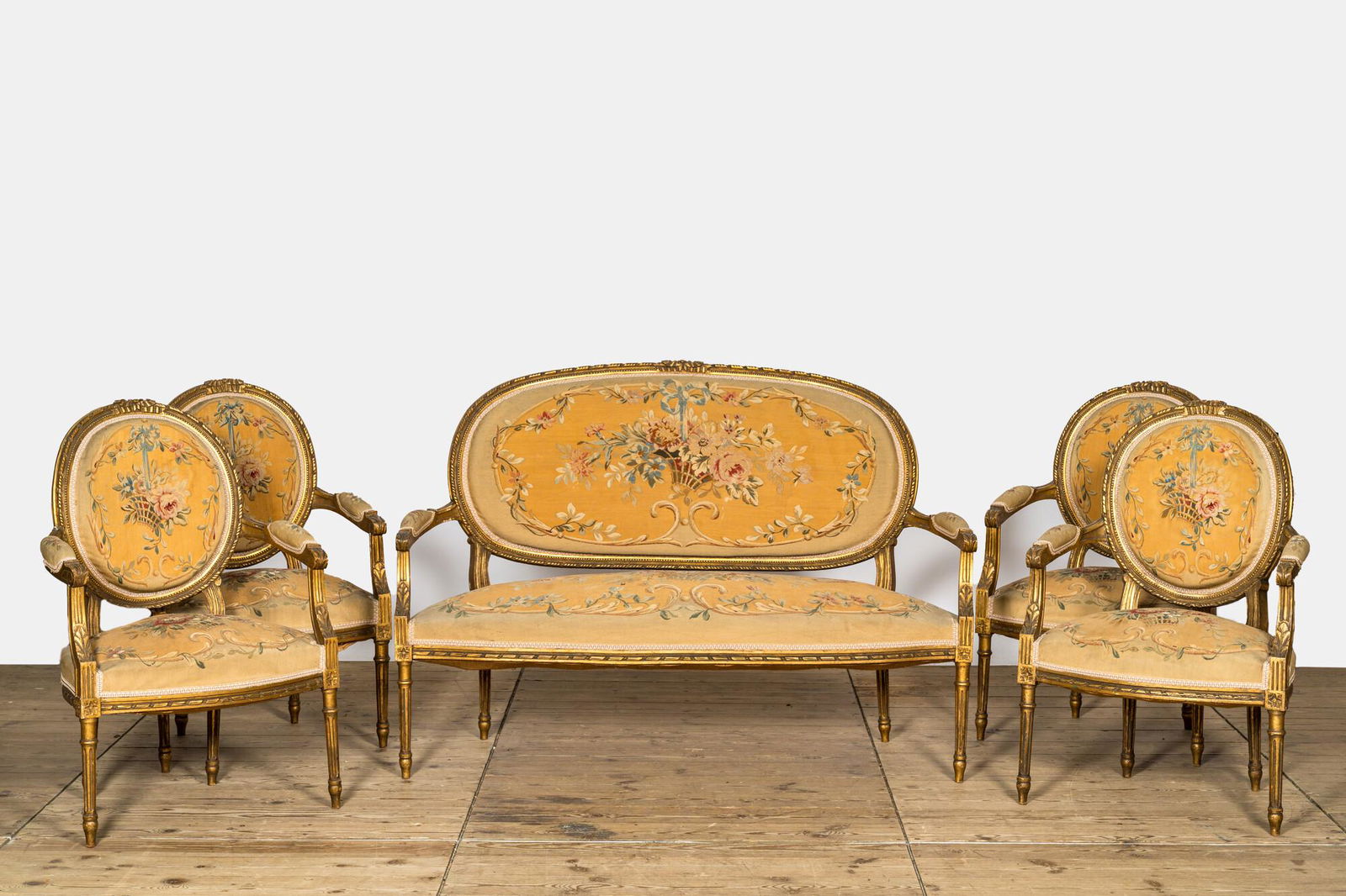 A French five-piece gilt wooden salon set comprising a sofa and four armchairs with embroidered (1 of 4)