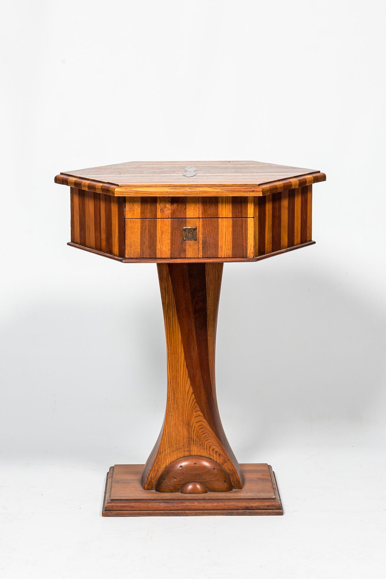 A hexagonal oak wooden and walnut work table on a central base, 19th C. (1 of 4)