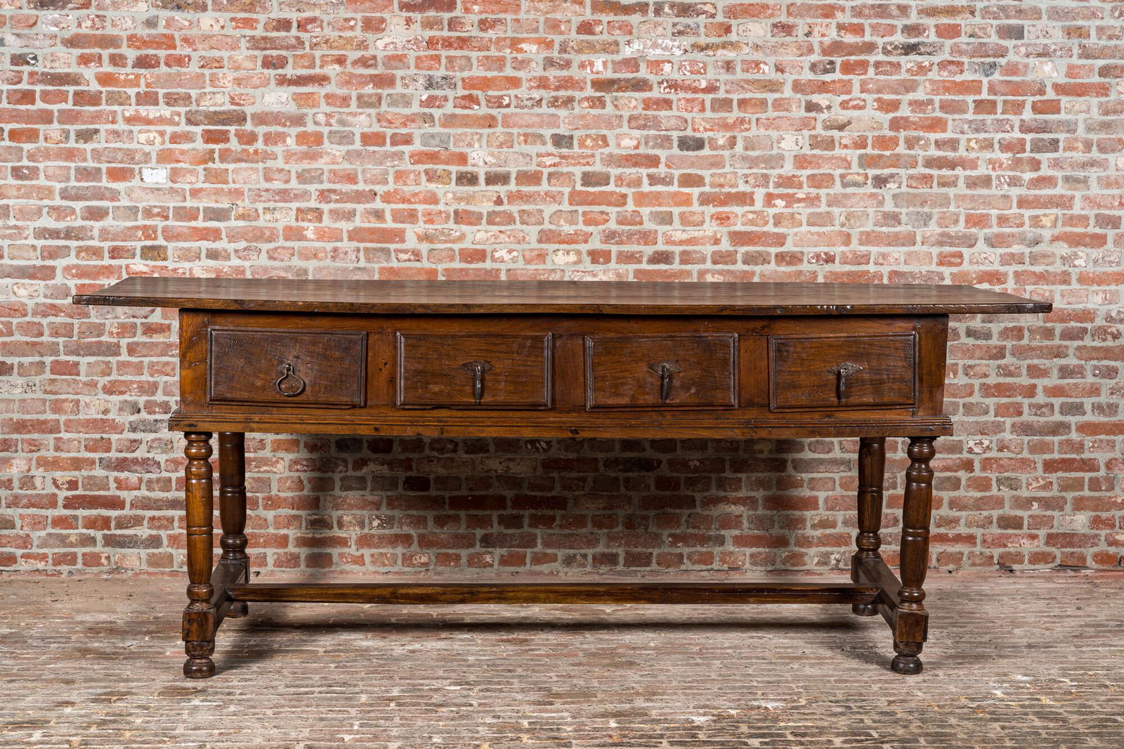 A four-drawer southern European walnut table, 18th C. and later (1 of 4)