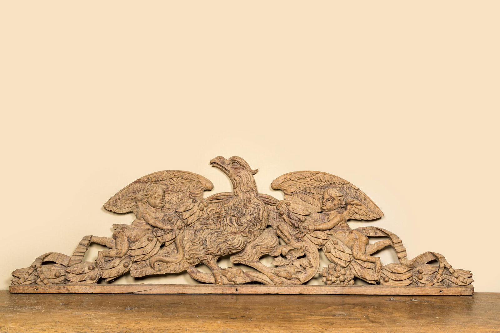 A large leached oak relief depicting an eagle slaying a serpent and two angels, 18th C. (1 of 3)