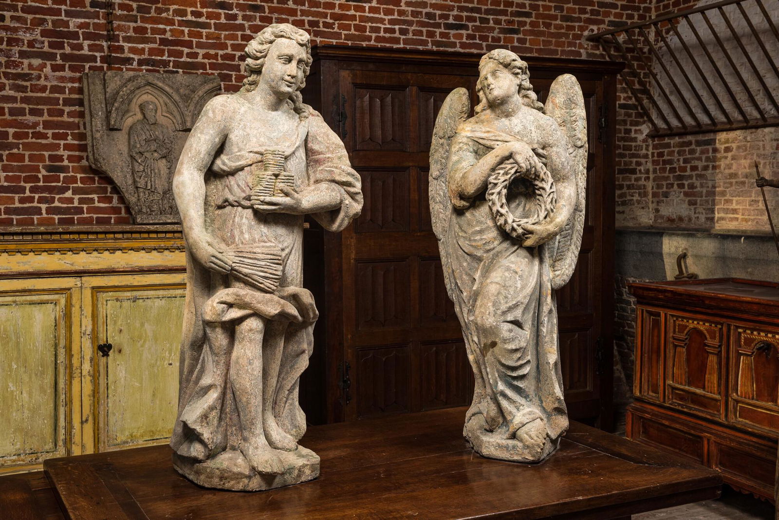 Two large stone sculptures of Judas holding crowns and an angel with a crown of thorns, 18th C. (1 of 3)