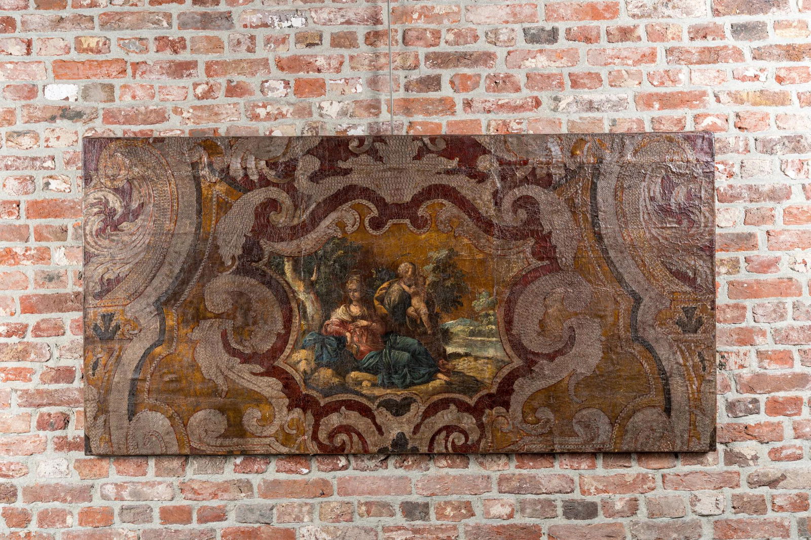 A Flemish painted leather panel depicting 'The Rest on the Flight into Egypt', 17th C. (1 of 2)