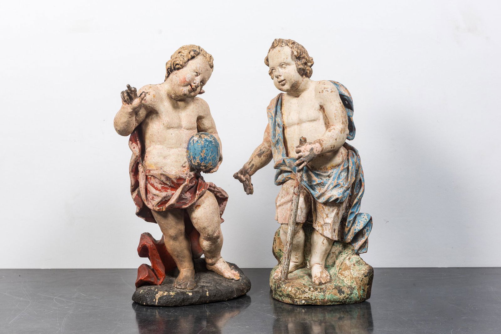 A pair of polychrome wooden putti, early 18th C. (1 of 2)
