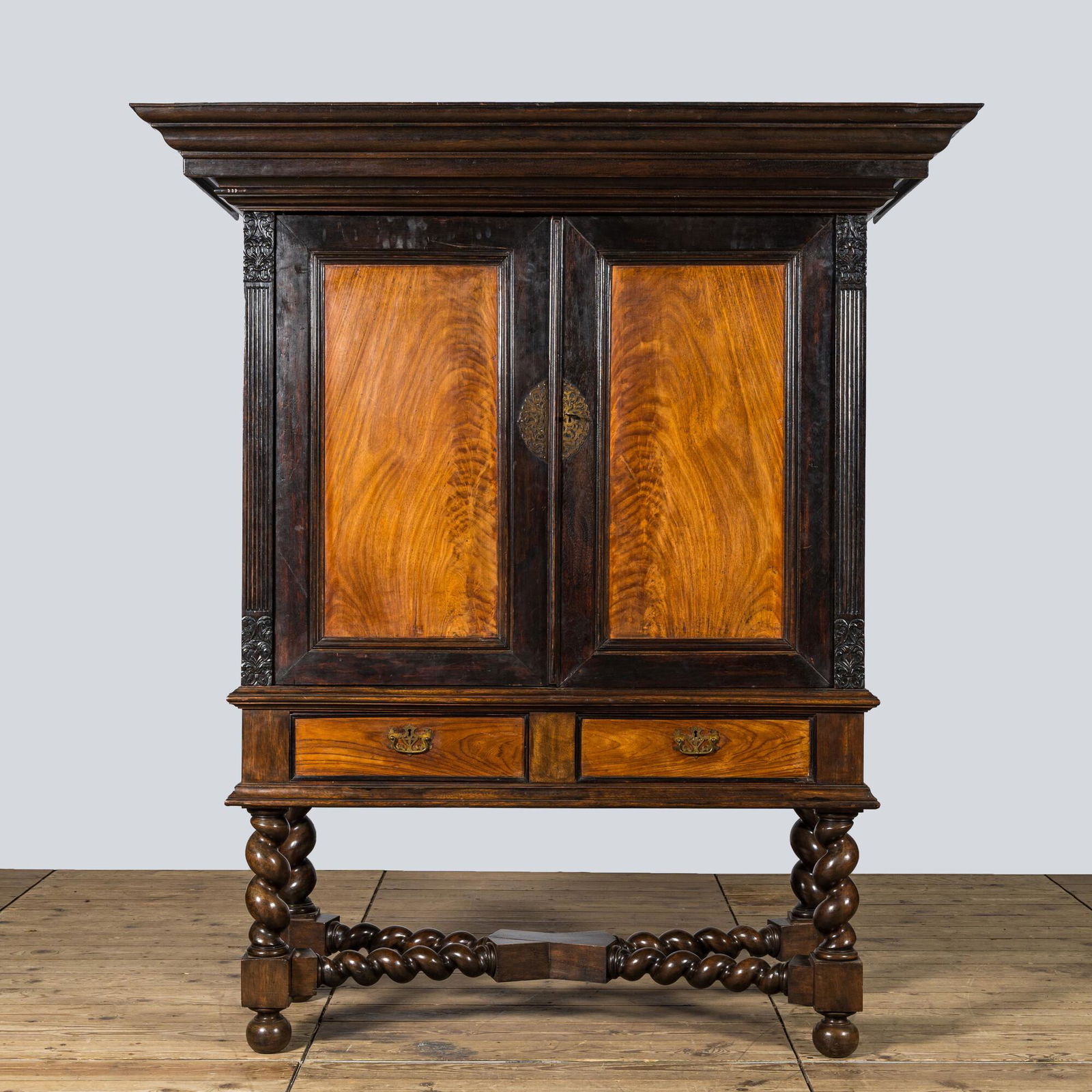 A mahogany and partly ebonised wooden two-door cupboard on foot, 19th C. (1 of 3)
