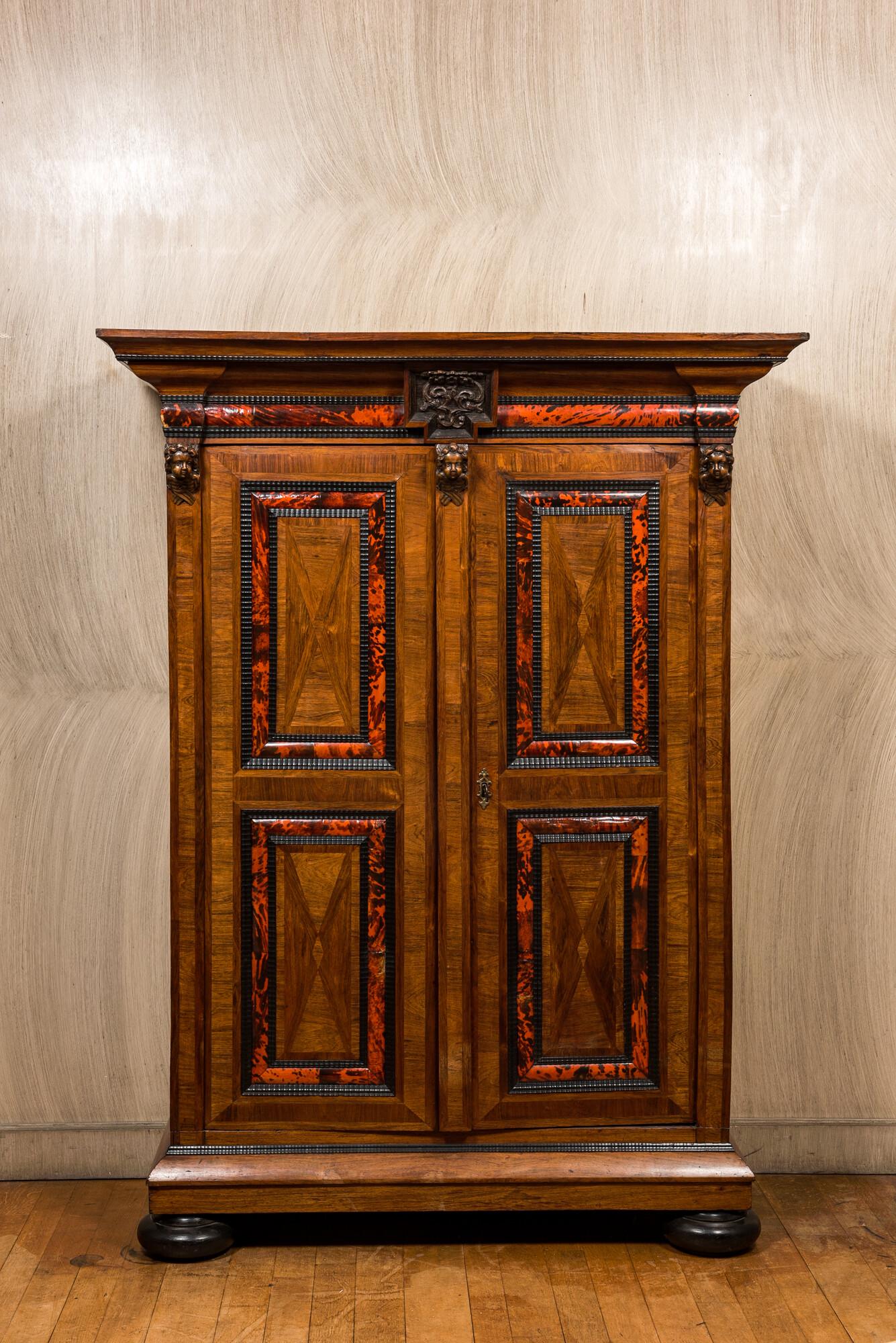 A Flemish wooden two-door cupboard with tortoiseshell and ebonised accents, 17th C. and later (1 of 8)