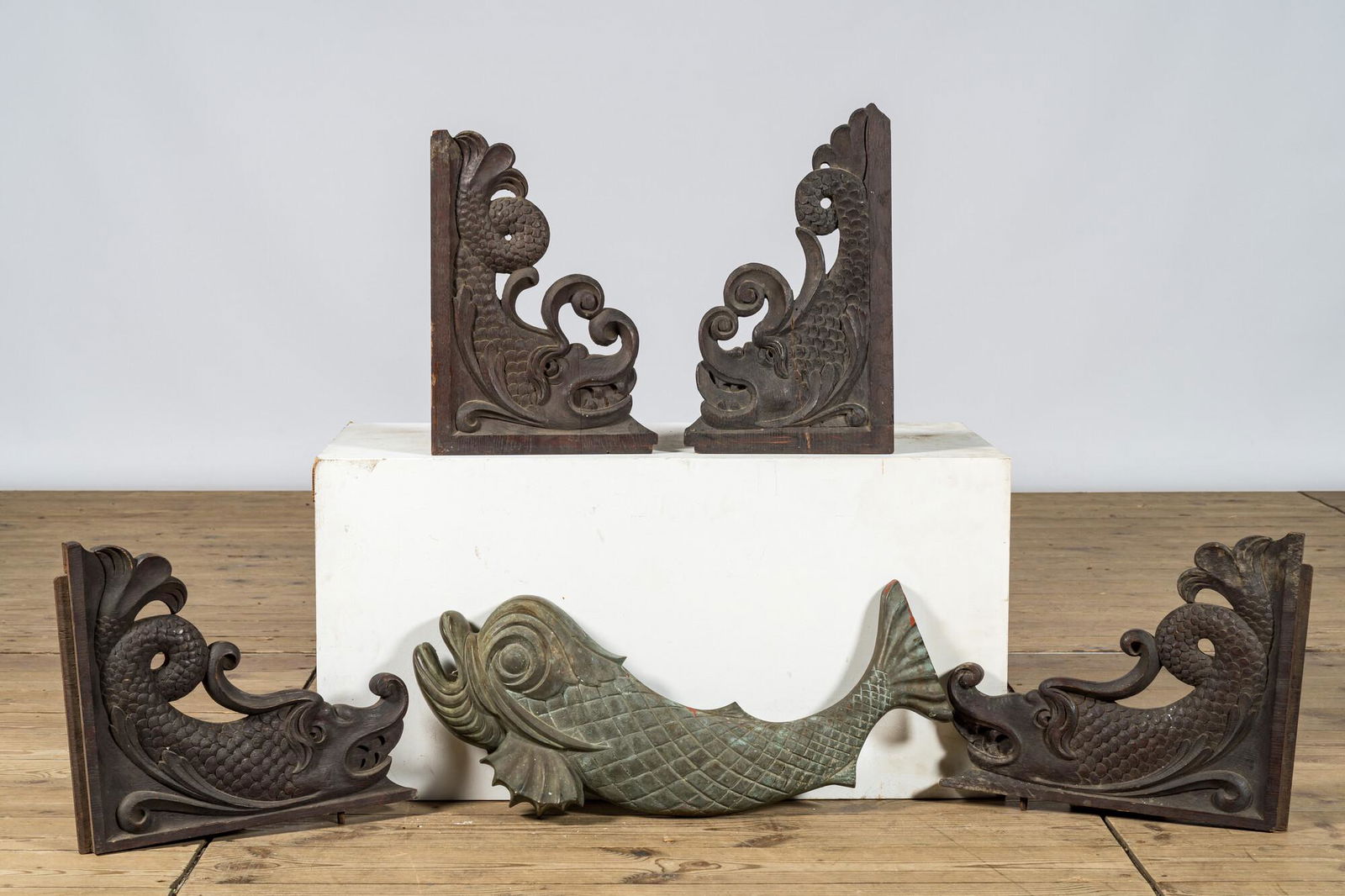 Four wooden 'dolphin' ornaments and a single bronze dolphin, 19/20th C. (1 of 1)