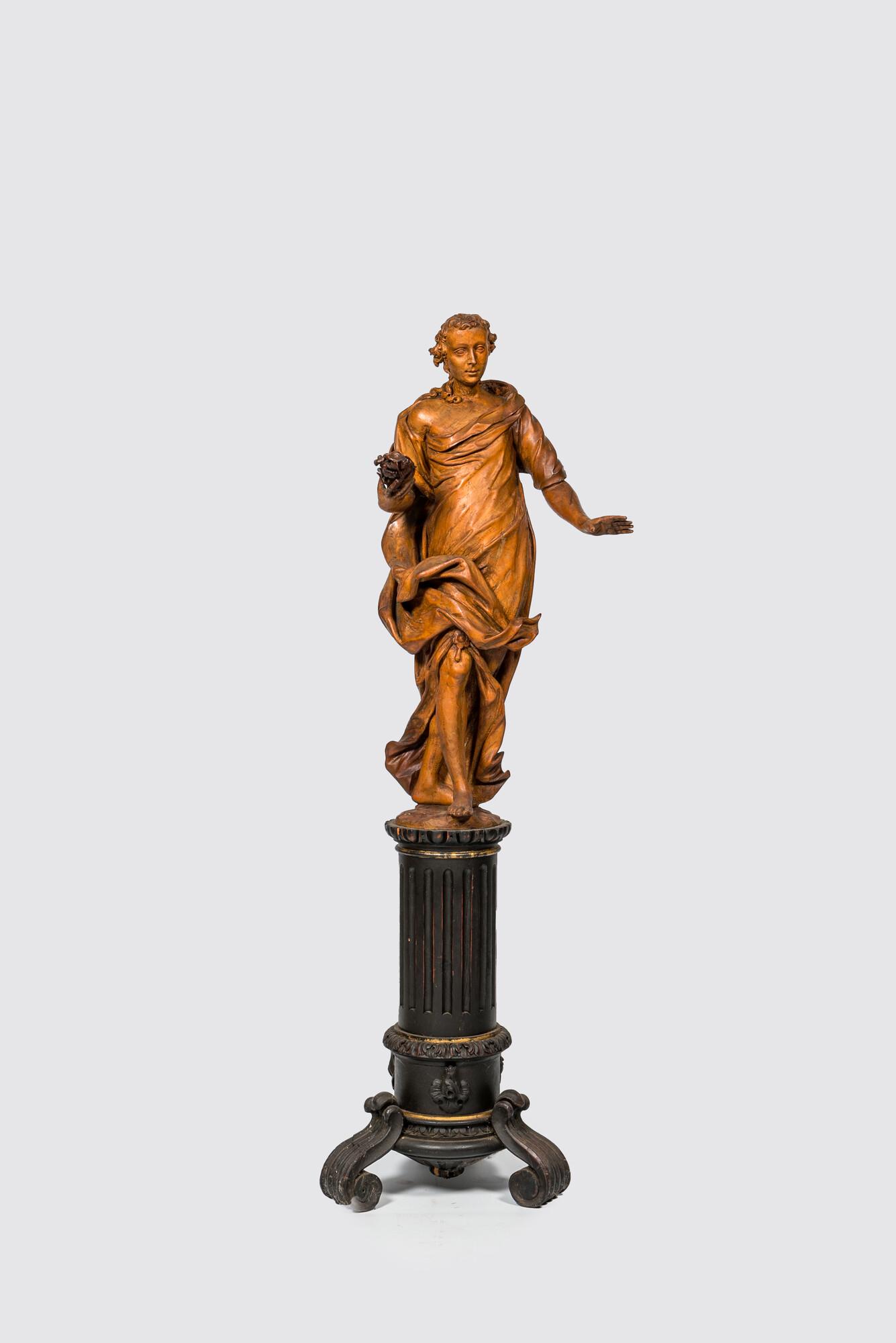 A basswooden allegorical 'Spring' figure on an ebonised neoclassical wooden base, 18/19th C. (1 of 3)
