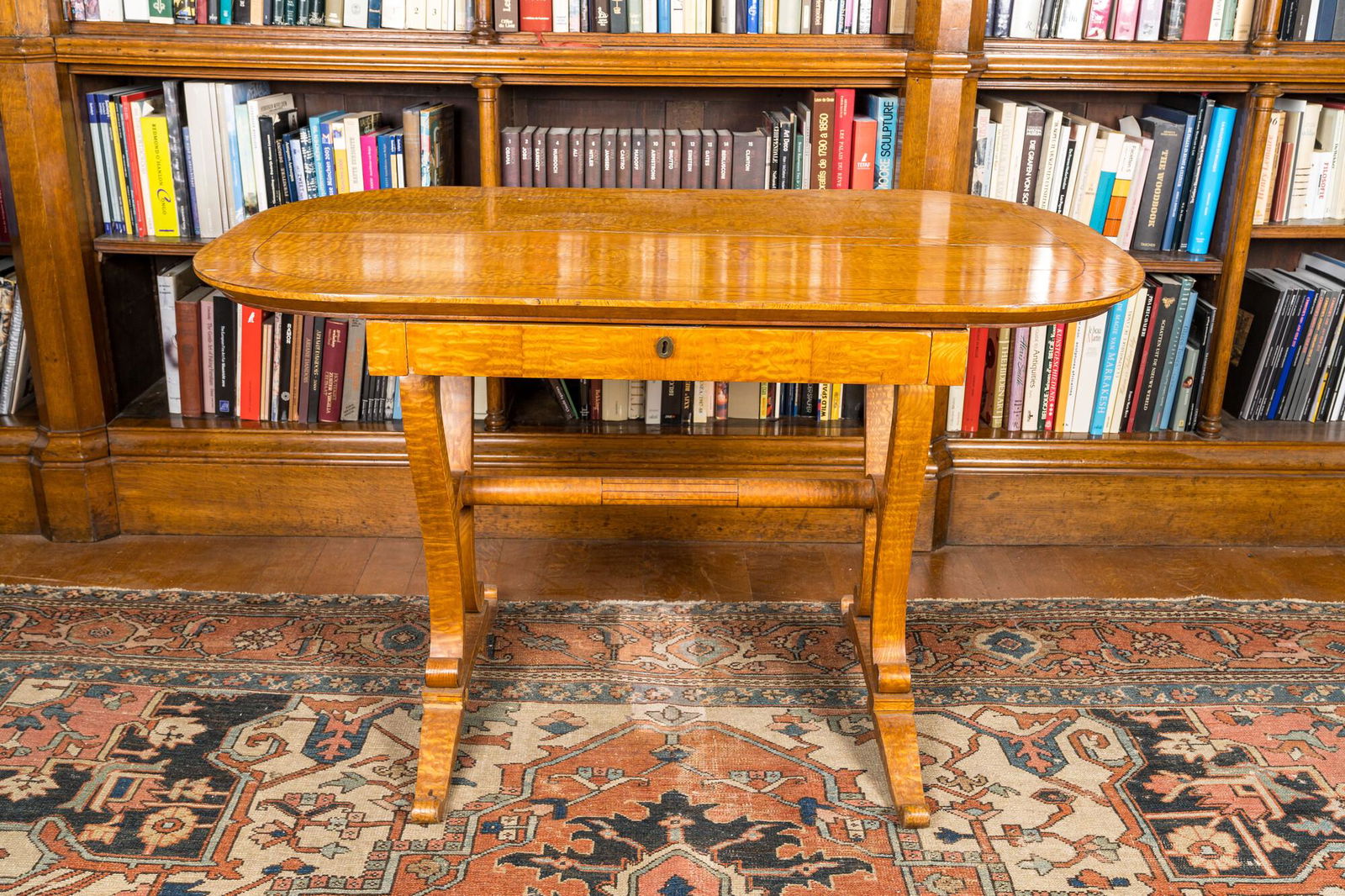 A German Biedermeier veneered table with a drawer, 19th C (1 of 3)