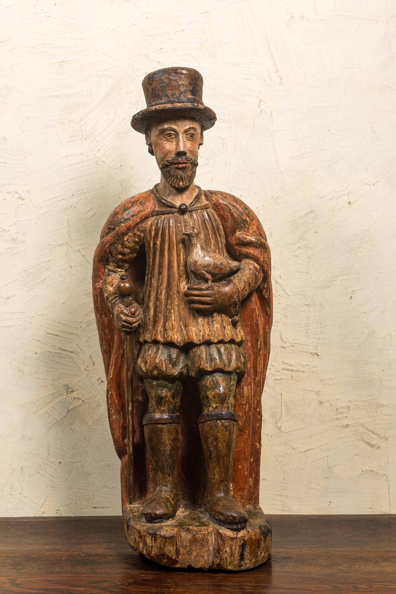 A Spanish polychrome walnut figure of a nobleman with a dove, 16/17th C. (1 of 3)