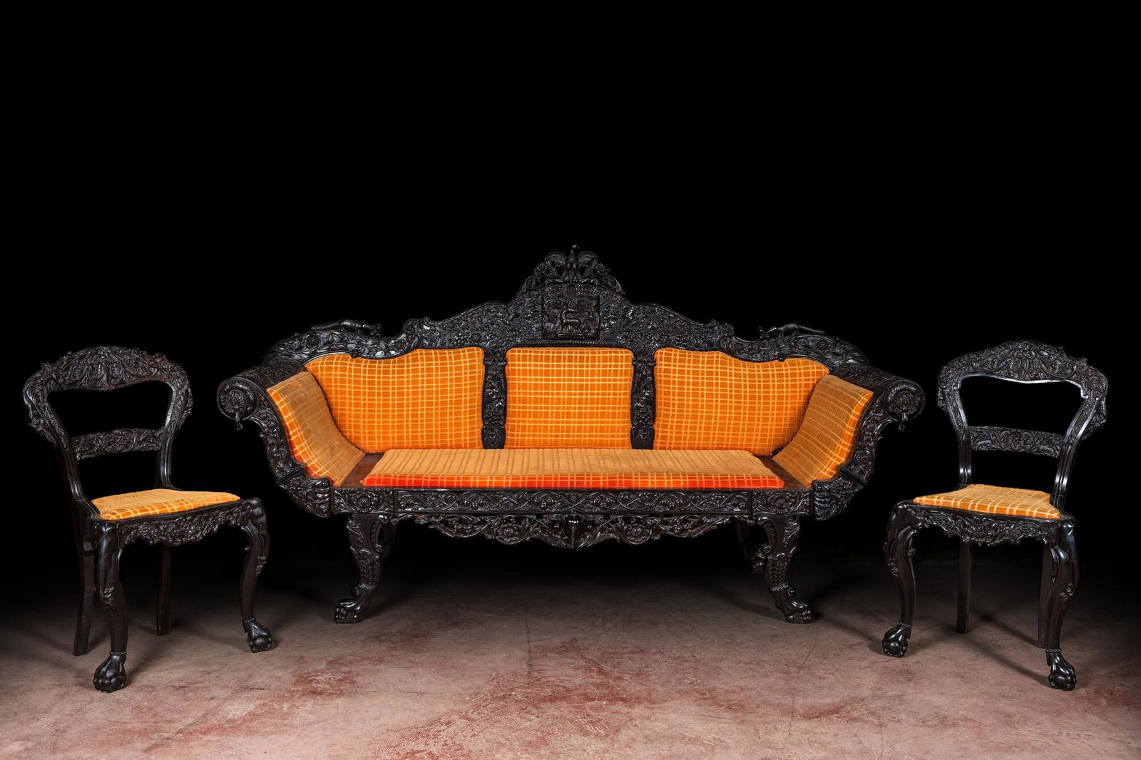 An Anglo-Indian colonial carved wooden sofa with two matching chairs, late 19th C. (1 of 5)