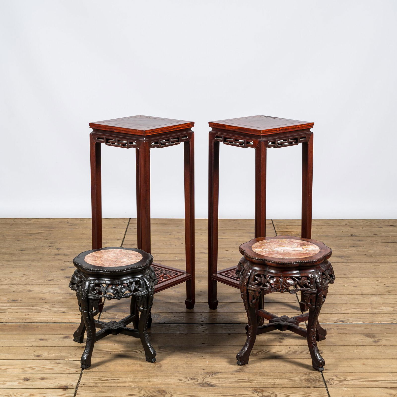 A pair of Chinese wooden square stands and two round ones with marble tops, 20th C. (1 of 3)