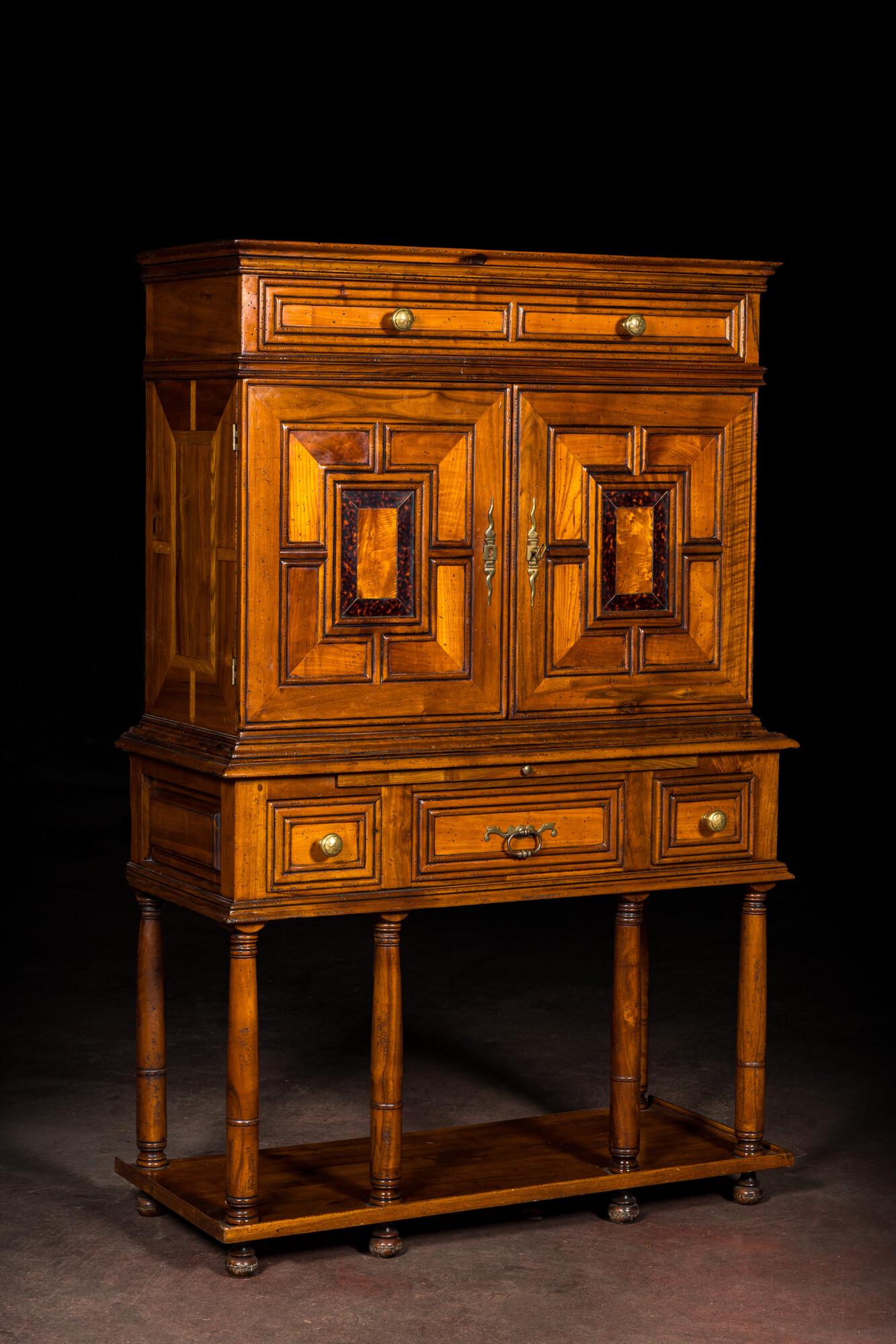 A cabinet on foot in various woods inlaid with faux tortoiseshell, 20th C. (1 of 8)
