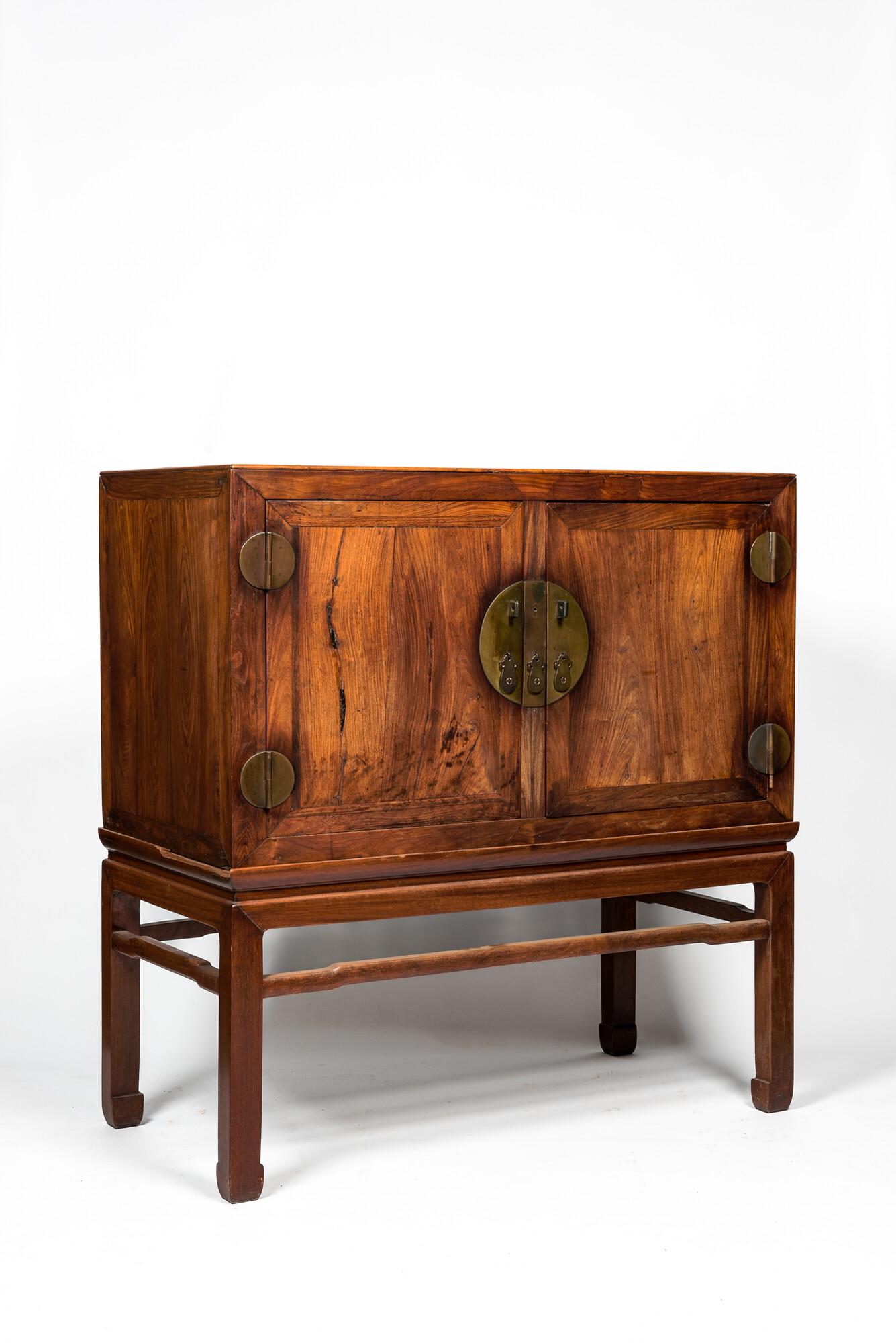 A Chinese hardwooden brass mounted two-door cabinet on foot, 20th C. (1 of 3)